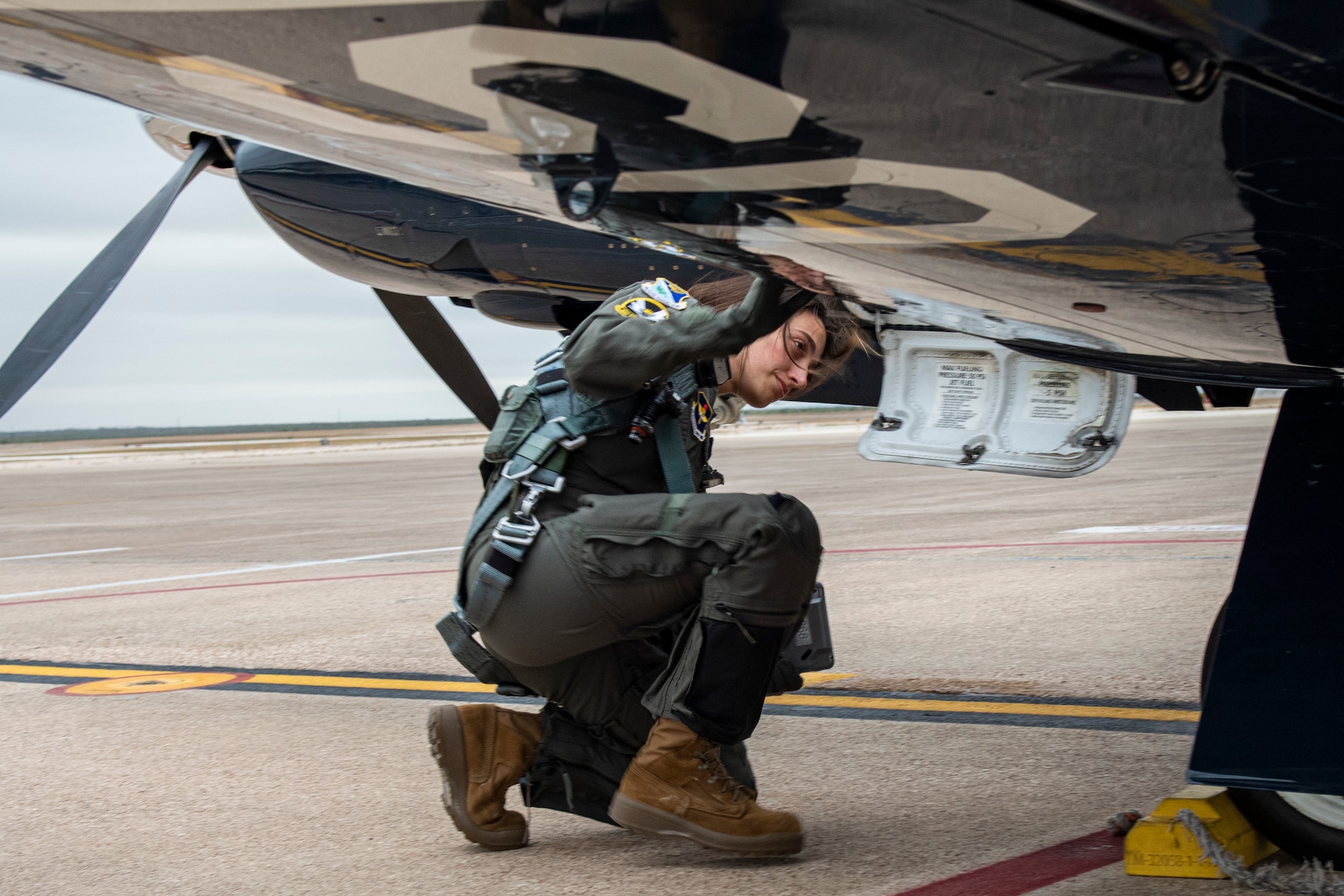 2nd Lt. Rosaria, 47th Flying Training Wing international student pilot, performs her pre-flight checks of a Texan II T-6 aircraft before take-off.  Laughlin Air Force Base assists in training pilots from allied countries from all around the globe. (These photos have been edited to hide the last name of the student) (U.S. Air Force photo by Senior Airman David Phaff)