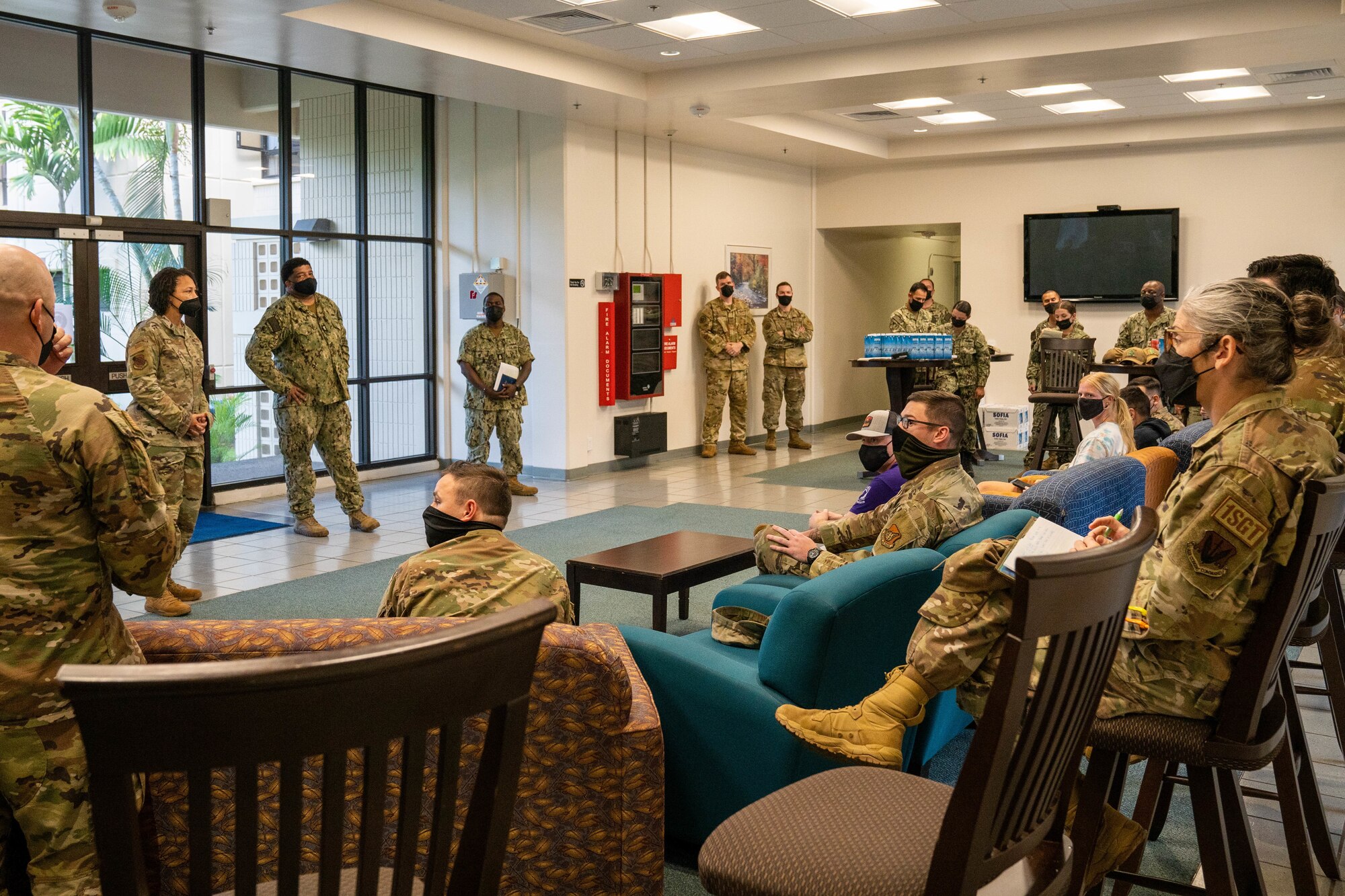 Chief Master Sgt. Sheronne King, 15th Wing command chief, engages with unaccompanied housing Airmen during a dormitory town hall at Joint Base Pearl Harbor-Hickam, Hawaii Dec. 16, 2021. Air Force leadership from JBPHH came together to address questions and concerns coming from Airmen living in the dorms regarding the current water quality recovery efforts. Leadership held the town hall to ensure the concerns about health and safety of each dorm resident is heard. (U.S. Air Force photo by Airman 1st Class Makensie Cooper)