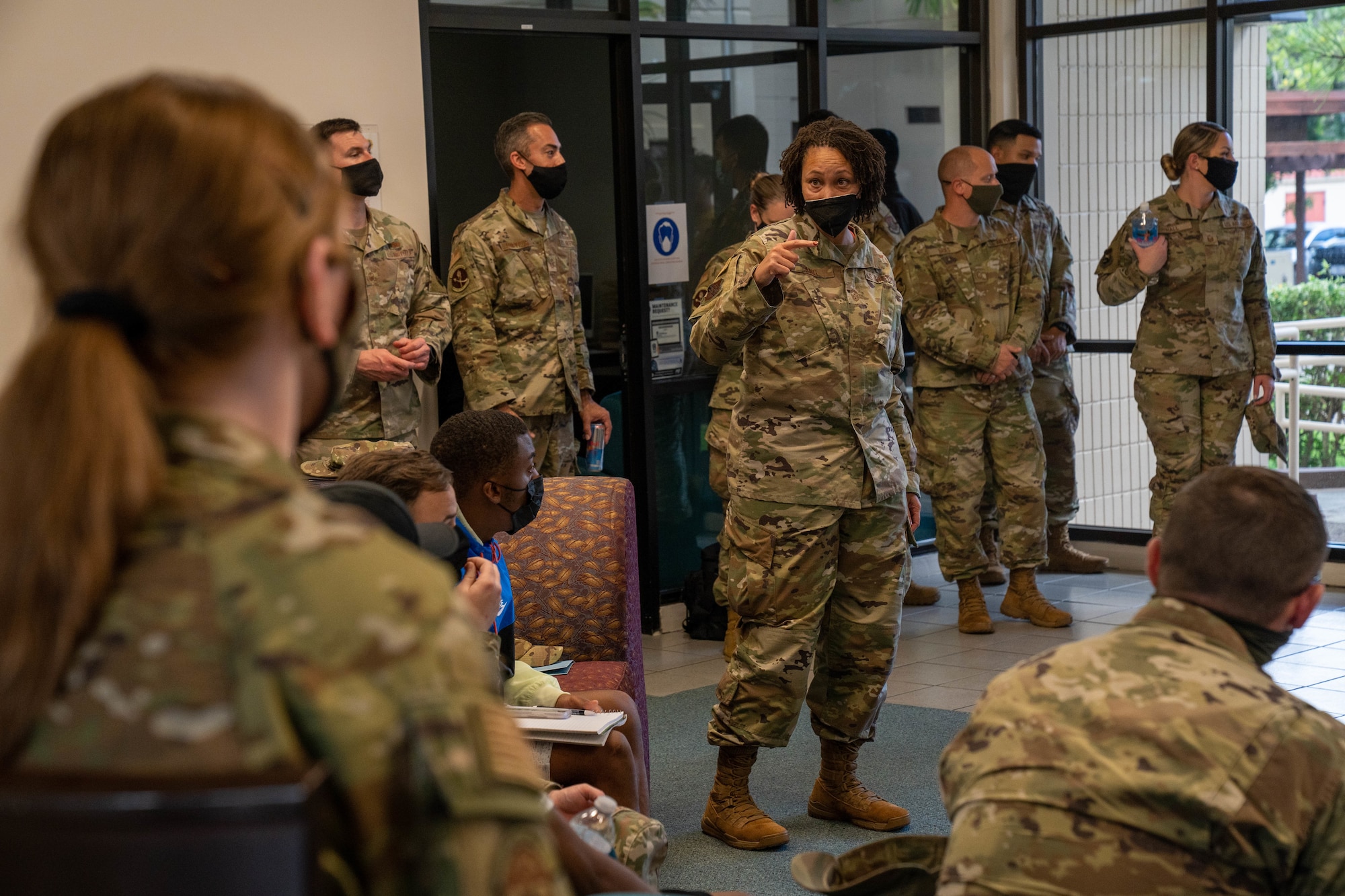 Chief Master Sgt. Sheronne King, 15th Wing command chief, briefs Airmen during a dormitory town hall at Joint Base Pearl Harbor-Hickam, Hawaii Dec. 16, 2021. Air Force leadership met with Airmen and had an open discussion addressing the concerns and questions regarding the water quality recovery efforts on base. (U.S. Air Force photo by Airman 1st Class Makensie Cooper)