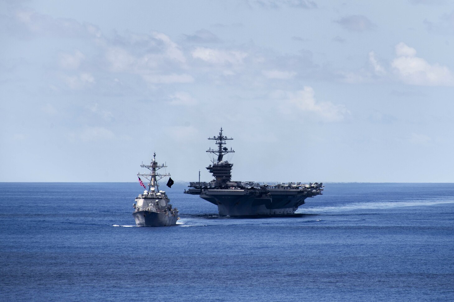 INDIAN OCEAN (Dec. 17, 2021) Arleigh Burke-class guided-missile destroyer USS Stockdale (DDG 106) and Nimitz-class aircraft carrier USS Carl Vinson (CVN 70) transit the Indian Ocean during a bilateral training exercise with the Royal Australian Air Force, Dec. 17, 2021. Carl Vinson Carrier Strike Group and elements of the Royal Australian Navy and Air Force are conducting a bilateral training exercise to test and refine warfighting capabilities in support of a free and open Indo-Pacific. (U.S. Navy photo by Mass Communication Specialist 2nd Class Haydn N. Smith)