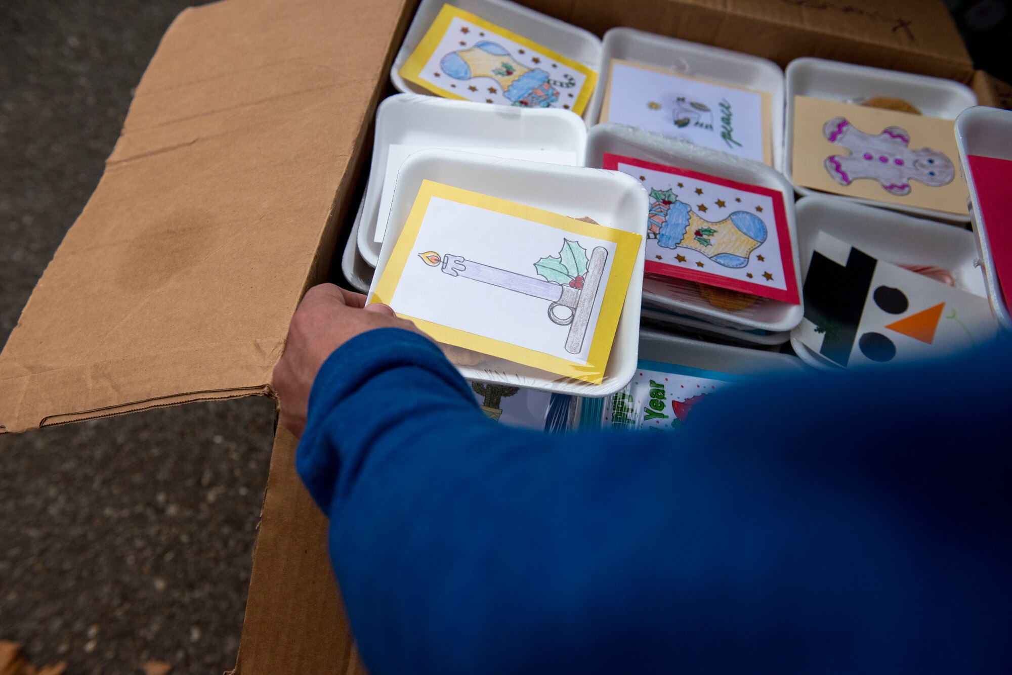 Master Sgt. Timothy Farmakis, 8th Medical Group first sergeant, arranges boxes of cookies for delivery as part of Operation Sweet Treat