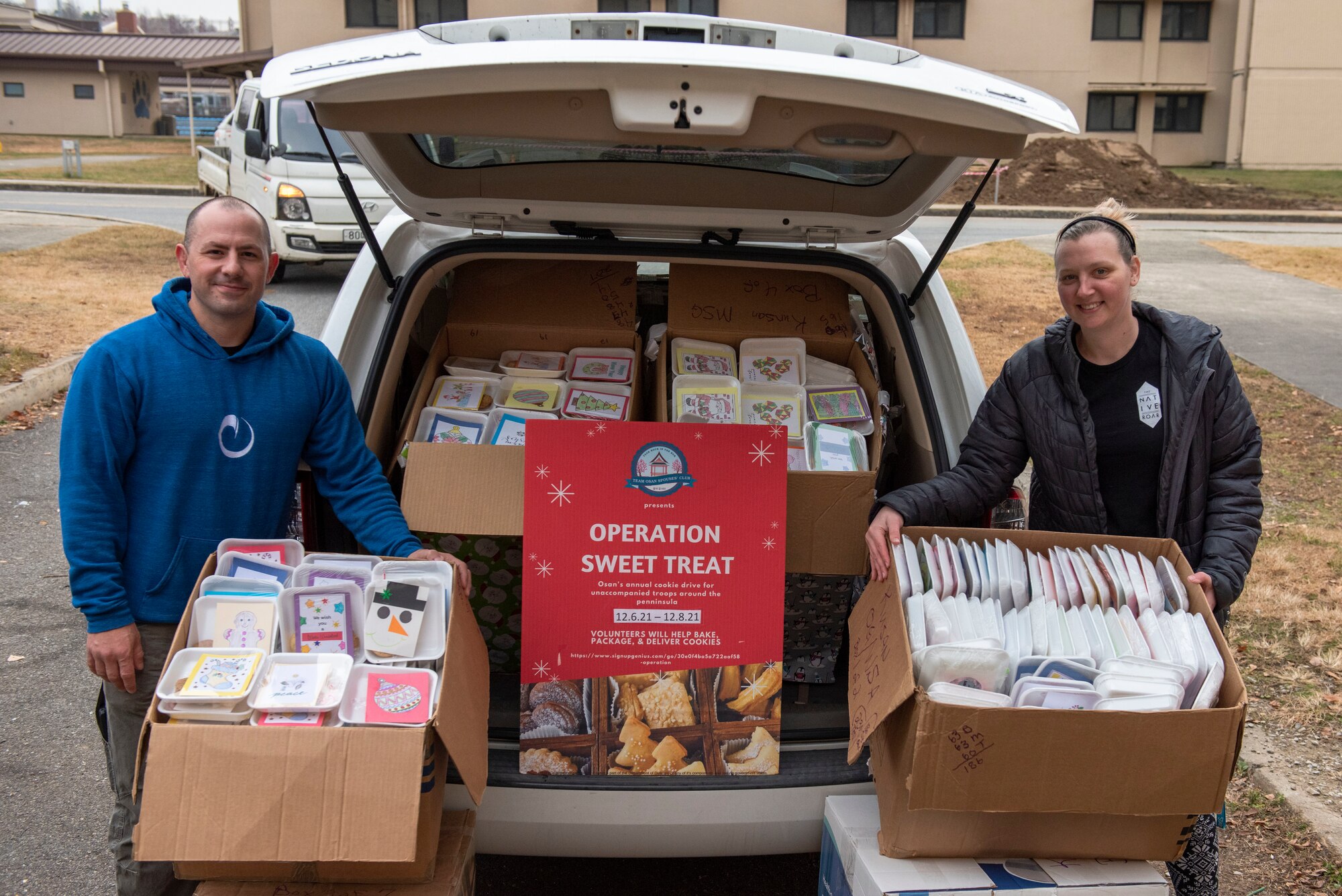 Master Sgt. Timothy Farmakis, 8th Medical Group first sergeant, left, and Mrs. Jenna Nunez, Team Osan Spouses Club (TOSC) president, prepare boxes of cookies as part of Operation Sweet Treat