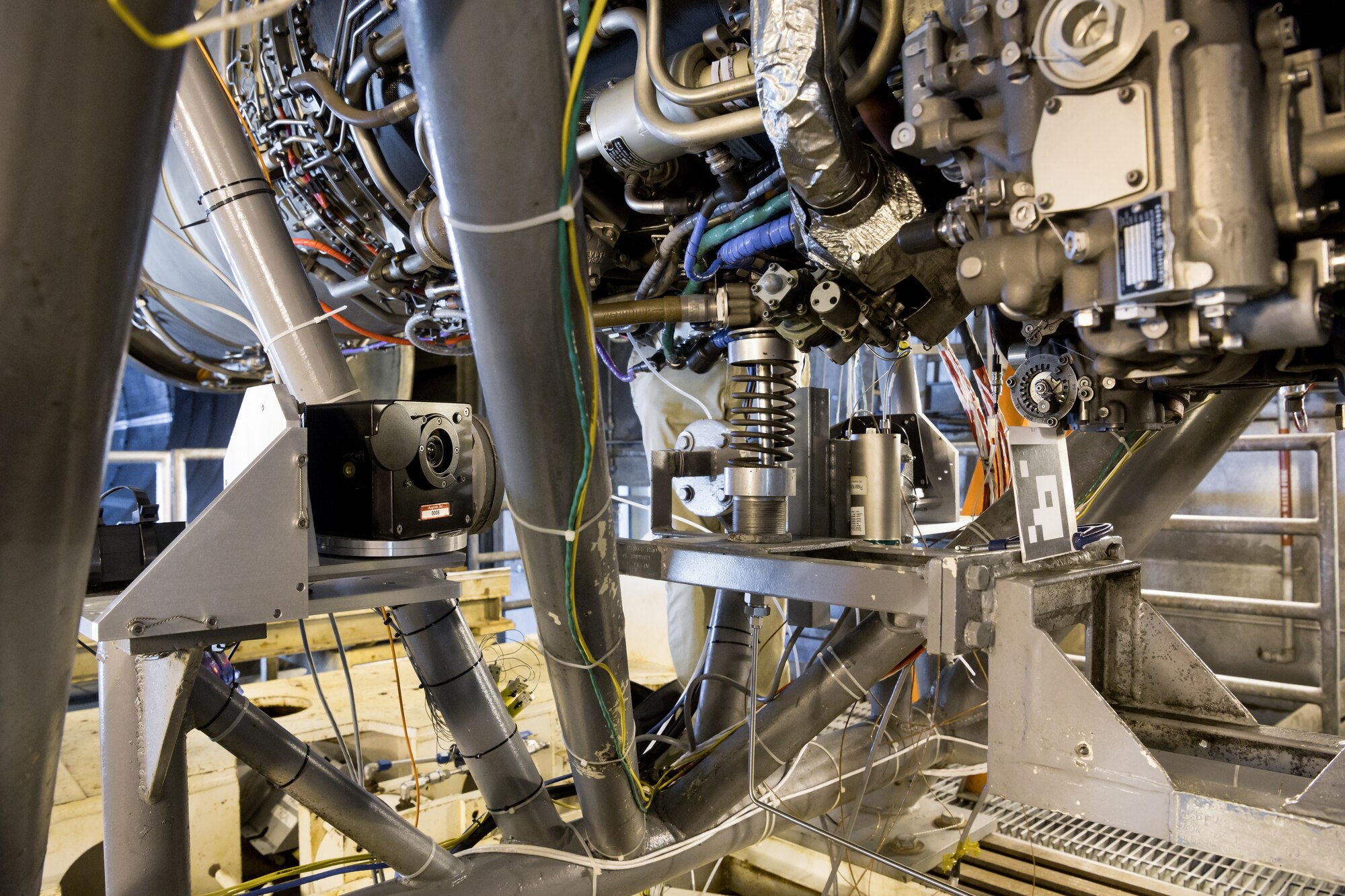 Cameras and registration symbols were placed around a General Electric F404 engine installation in Sea Level Test Cell 1 during sensor testing for a trial of the Virtual Test Cell Presence System, June 15, 2021, at Arnold Air Force Base, Tenn.