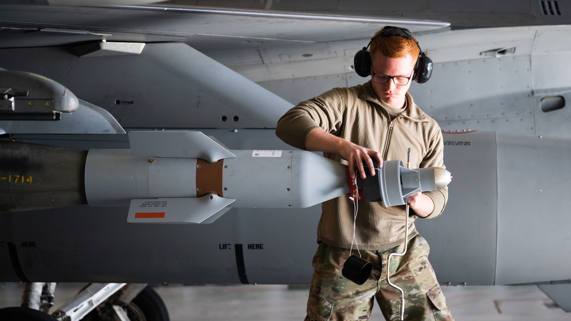 U.S. Air Force Airman 1st Class Jacob Weding, 378th Expeditionary Maintenance Squadron aircraft armament systems specialist, loads munitions onto an F-16 Fighting Falcon at King Fahad Air Base, Kingdom of Saudi Arabia, Dec. 7, 2021. U.S. and KSA forces conducted combined operations to better integrate partner capabilities. (U.S. Air Force photo by Senior Airman Jacob B. Wrightsman)