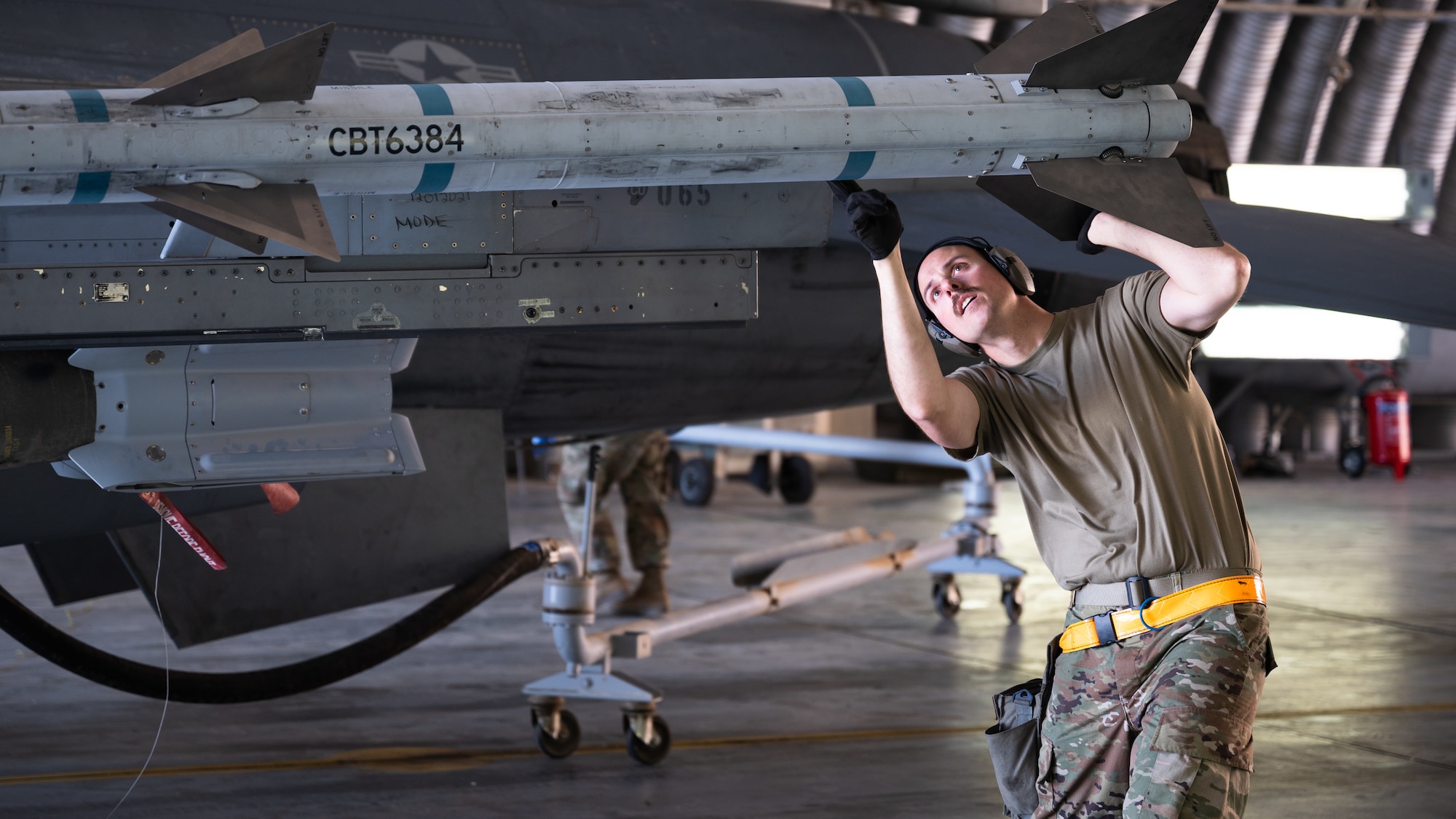 Tech. Sgt. Joseph Wetzel, 378th Expeditionary Maintenance Squadron weapons systems crew chief, inspects munitions during a integrated combat turn at King Fahad Air Base, Kingdom of Saudi Arabia, Dec. 7, 2021. U.S. and Saudi forces conducted combined operations, further cultivating strong partnerships in order to deter regional aggressors. (U.S. Air Force photo by Senior Airman Jacob B. Wrightsman)