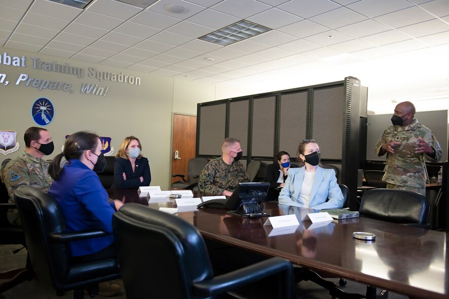 Dr. Kathleen Hicks, the Deputy Secretary of Defense receives a mission briefing from U.S. Space Force Lt Col. Albert Harris, Commander of the 392d Combat Training Squadron at Schriever Space Force Base, Colorado, Dec. 13, 2021.  The 392d Combat Training Squadron provides space combat training through live, virtual, and constructive environments to prepare warfighters to win. (U.S. Space Force photo by Judi Tomich)
