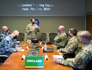 U.S. Space Force Brig Gen Todd Moore, Space Training and Readiness Command Deputy Commander, and distinguished visitors from the United Kingdom, and Australia discuss key topics during SPACE FLAG 22-1 at Schriever Space Force Base, Colorado, Dec. 13, 2021. From left to right: Air Cdre Nicholas Hogan, Director General Space Domain Review, AUS, John Haly, Air and Space Attache,  AUS, Brig Gen Todd Moore, Deputy Commander, STARCOM, Air Vice-Marshall Harvey “Harv” Smyth, Director Space UK, Air Vice-Marshall Paul Godfrey, Commander UK Space Command, Air Cdre JJ “Jez” Attridge, UK. (U.S. Space Force photo by Judi Tomich)
