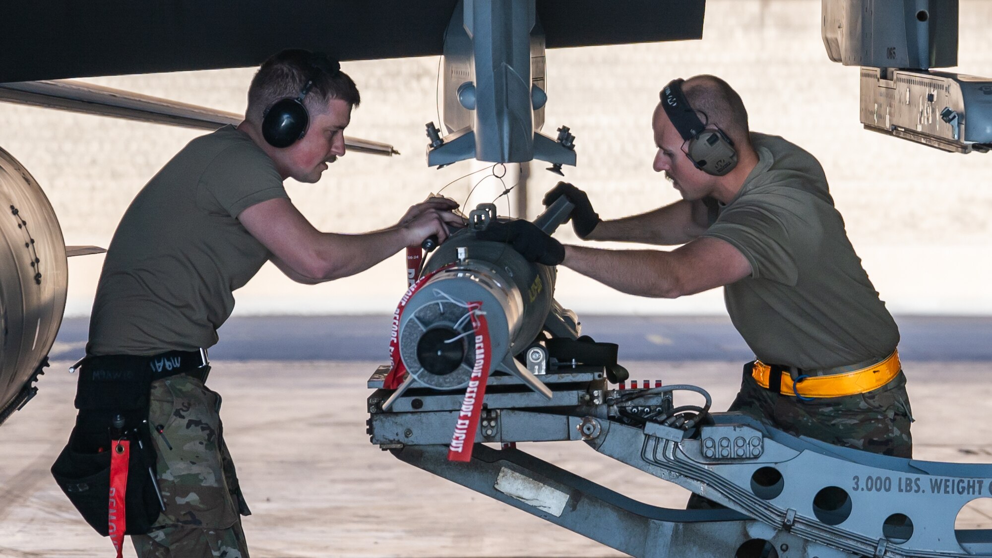 Staff Sgt. Turner Hombsch, 378th Expeditionary Maintenance Squadron aircraft armament systems specialist, and Tech Sgt. Joseph Wetzel, 378th EMXS weapons systems crew chief, load munitions onto an F-16 Fighting Falcon at King Fahad Air Base, Kingdom of Saudi Arabia, Dec. 7, 2021. The exercise tested the 378th Air Expeditionary Wing's Agile Combat Employment skills to rapidly deploy and maneuver around the U.S. Central Command area of responsibility. (U.S. Air Force photo by Senior Airman Jacob B. Wrightsman)