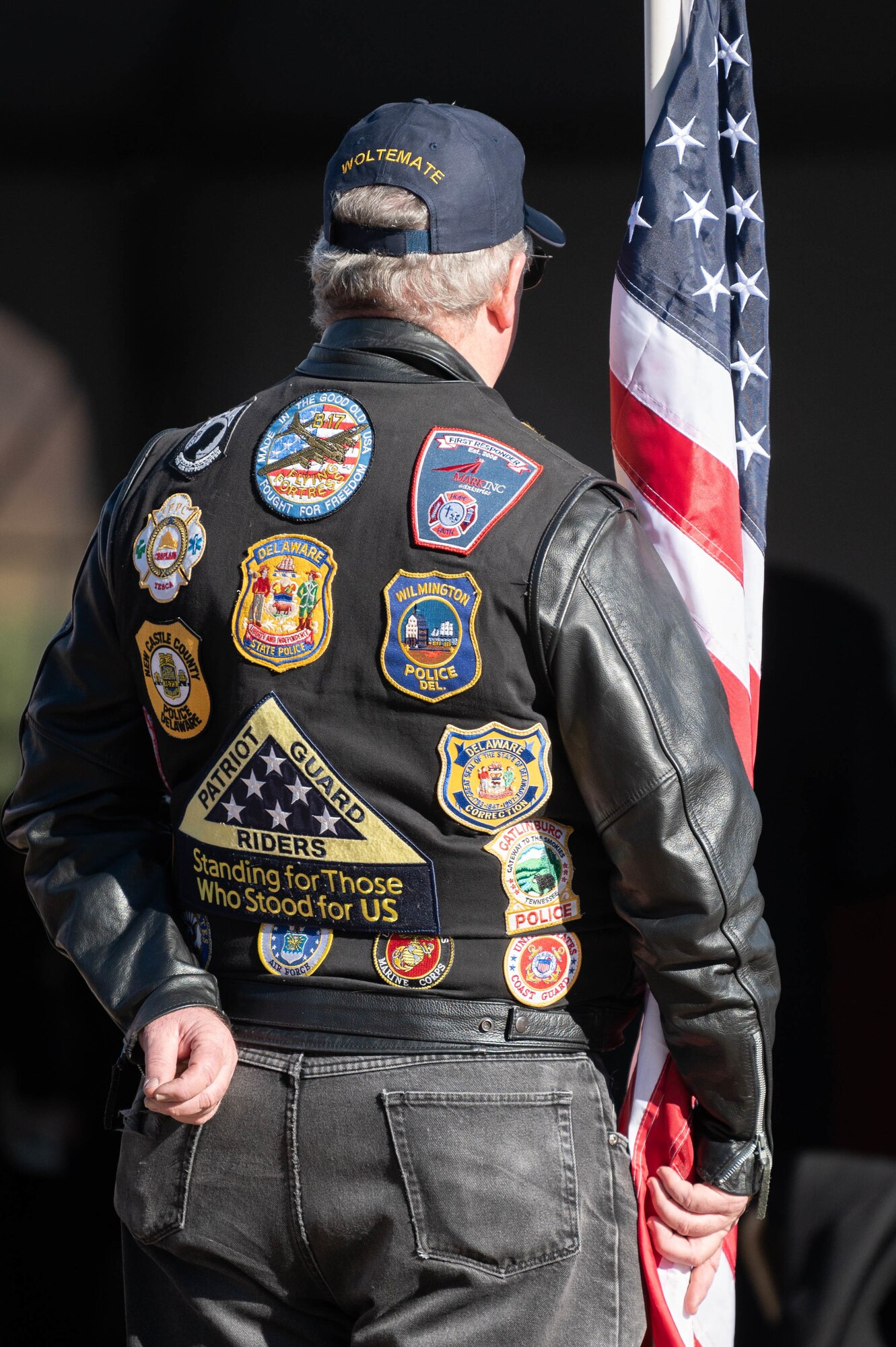 A member of the Patriot Guard Riders holds an American flag at the Delaware Wreaths Across America event Dec. 13, 2021 in Dover, Delaware. After the ceremony, wreaths were laid at various war memorials in downtown Dover. (U.S. Air Force photo by Mauricio Campino)