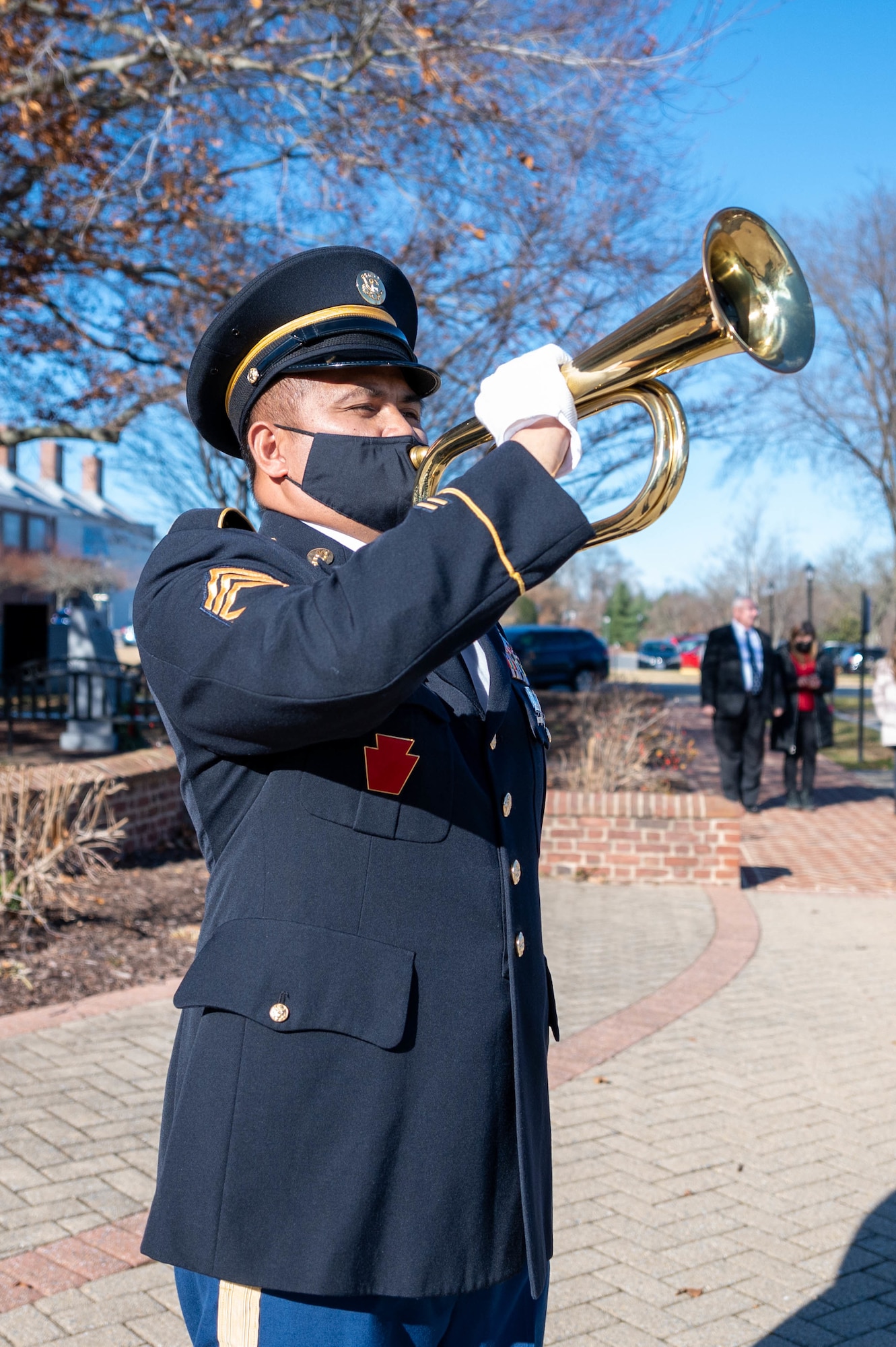 U.S. Army Sgt. 1st Class Jessier Belfast, 198th Expeditionary Signal Battalion administration supervisor, plays Taps at the conclusion of the Delaware Wreaths Across America event Dec. 13, 2021 in Dover, Delaware. After the ceremony, wreaths were laid at various war memorials in downtown Dover. (U.S. Air Force photo by Mauricio Campino)