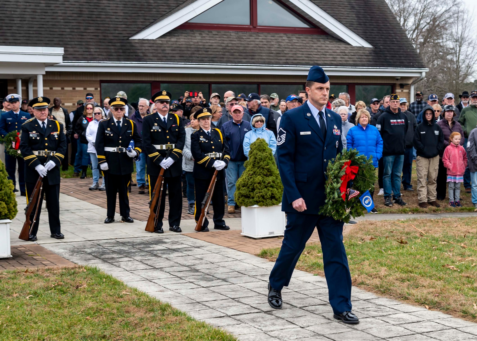 Master Sgt. Jason Brede, 436th Airlift Wing Staff Agency first sergeant, carries a wreath during a wreath laying ceremony at the Delaware Veterans Memorial Cemetery in Millsboro, Delaware, Dec. 18, 2021. Each December, on National Wreaths Across America Day, wreath laying ceremonies are held across the country at more than 2,100 cemeteries, honoring veterans and those who have fallen. (U.S. Air Force photo by Senior Airman Stephani Barge)