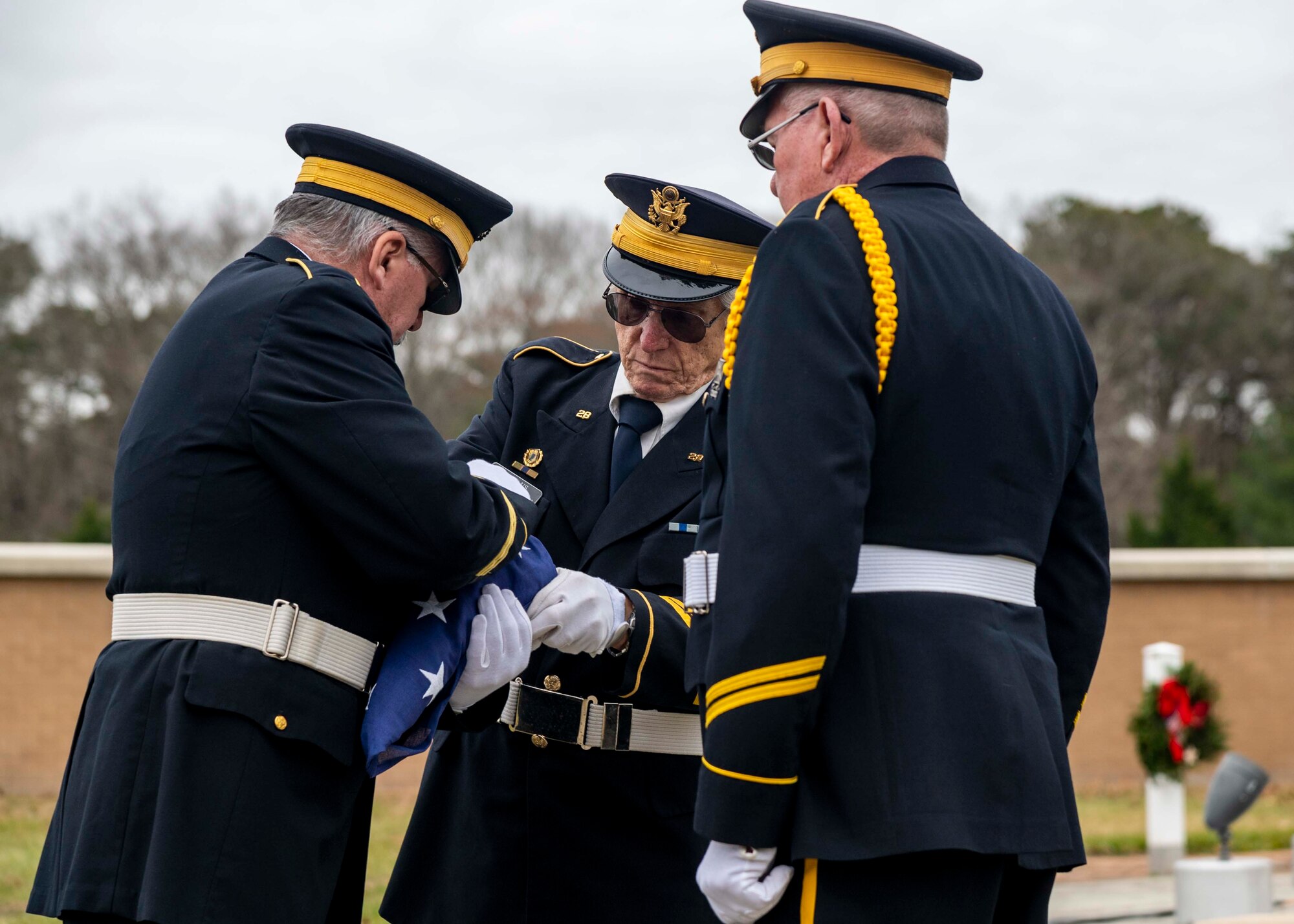 Members of an American Legion flag detail fold the U.S. flag during a wreath laying ceremony at the Delaware Veterans Memorial Cemetery in Millsboro, Delaware, Dec. 18, 2021. Each December, on National Wreaths Across America Day, wreath laying ceremonies are held across the country at more than 2,100 cemeteries, honoring veterans and those who have fallen. (U.S. Air Force photo by Senior Airman Stephani Barge)