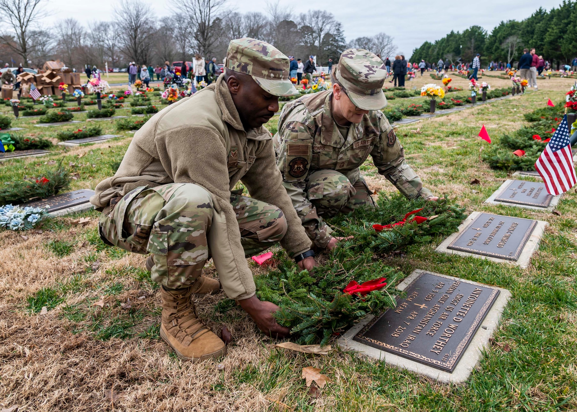 Airmen from the 512th Mortuary Affairs Squadron lay wreaths on a grave at the Delaware Veterans Memorial Cemetery in Millsboro, Delaware, Dec. 18, 2021. Each December, on National Wreaths Across America Day, wreath laying ceremonies are held across the country at more than 2,100 cemeteries, honoring veterans and those who have fallen. (U.S. Air Force photo by Senior Airman Stephani Barge)