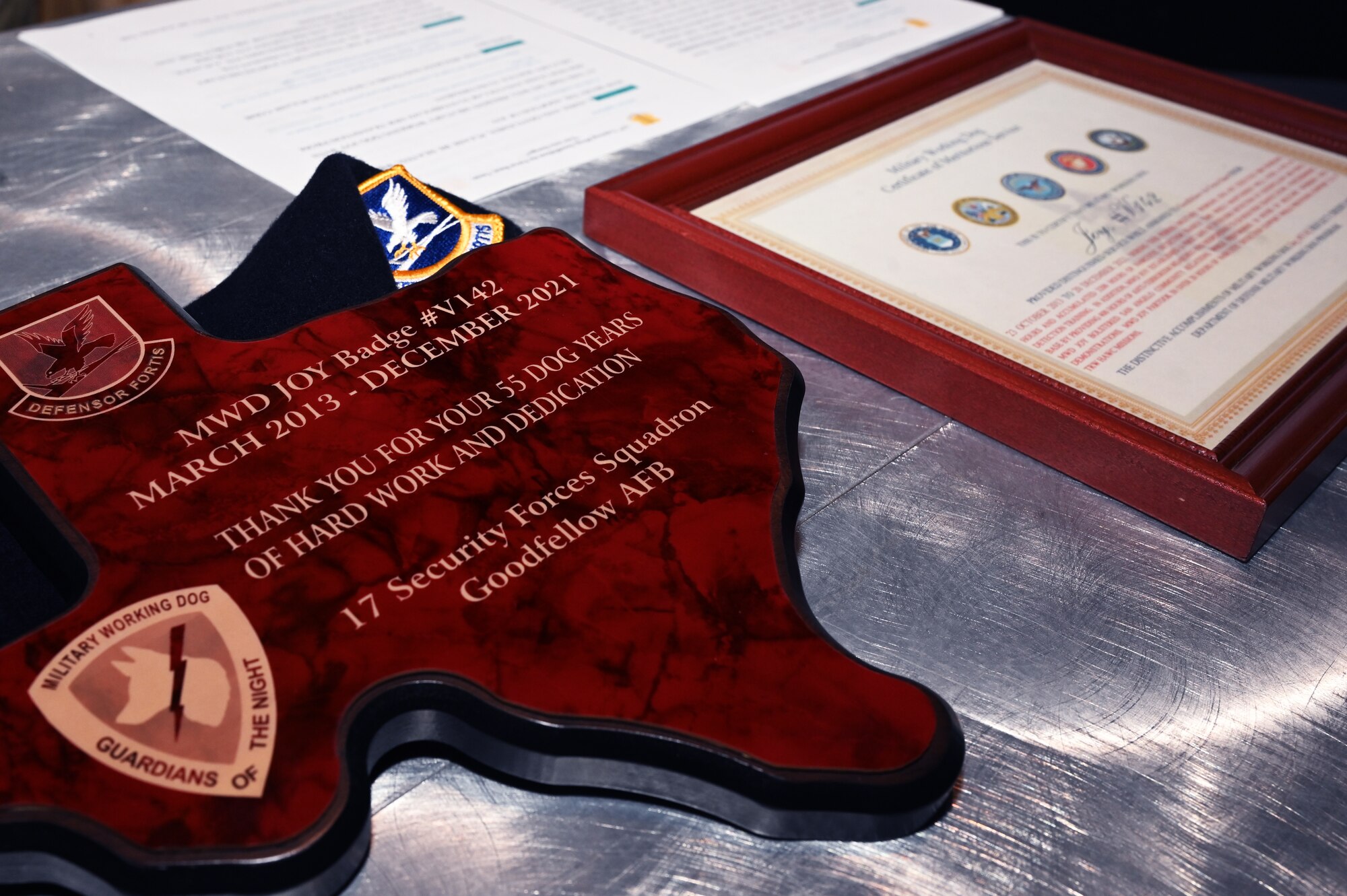 17th Security Forces Squadron Military Working Dog Joy is recognized during her retirement ceremony at the theater on Goodfellow Air Force Base, Dec. 20. Joy was awarded a Military Working Dog Certificate of Meritorious Service for her time as a member of the 17th SFS. (U.S. Air Force photo by Senior Airman Michael Bowman)