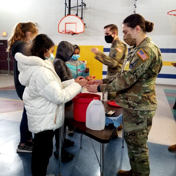 The Air Force Research Laboratory’s Lt. Mary Albrecht, a deployable structures engineer (right) and Lt. Chance Baxter, assistant to the Deputy Technology Executive for Space Science and Technology, provide hands-on demonstration of thermal concepts that affect space exploration, to 4th graders at Sandia Base Elementary School. (Courtesy photo)