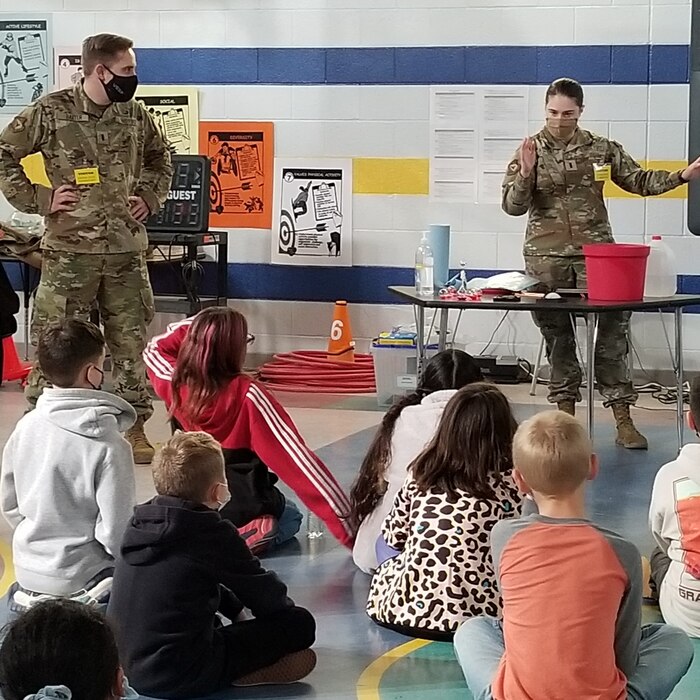 The Air Force Research Laboratory’s Lt. Mary Albrecht, a deployable structures engineer (right) and Lt. Chance Baxter, assistant to the Deputy Technology Executive for Space Science and Technology, explain the problems that must be solved before a satellite can be launched into space, to 4th graders at Sandia Base Elementary School. (Courtesy photo)