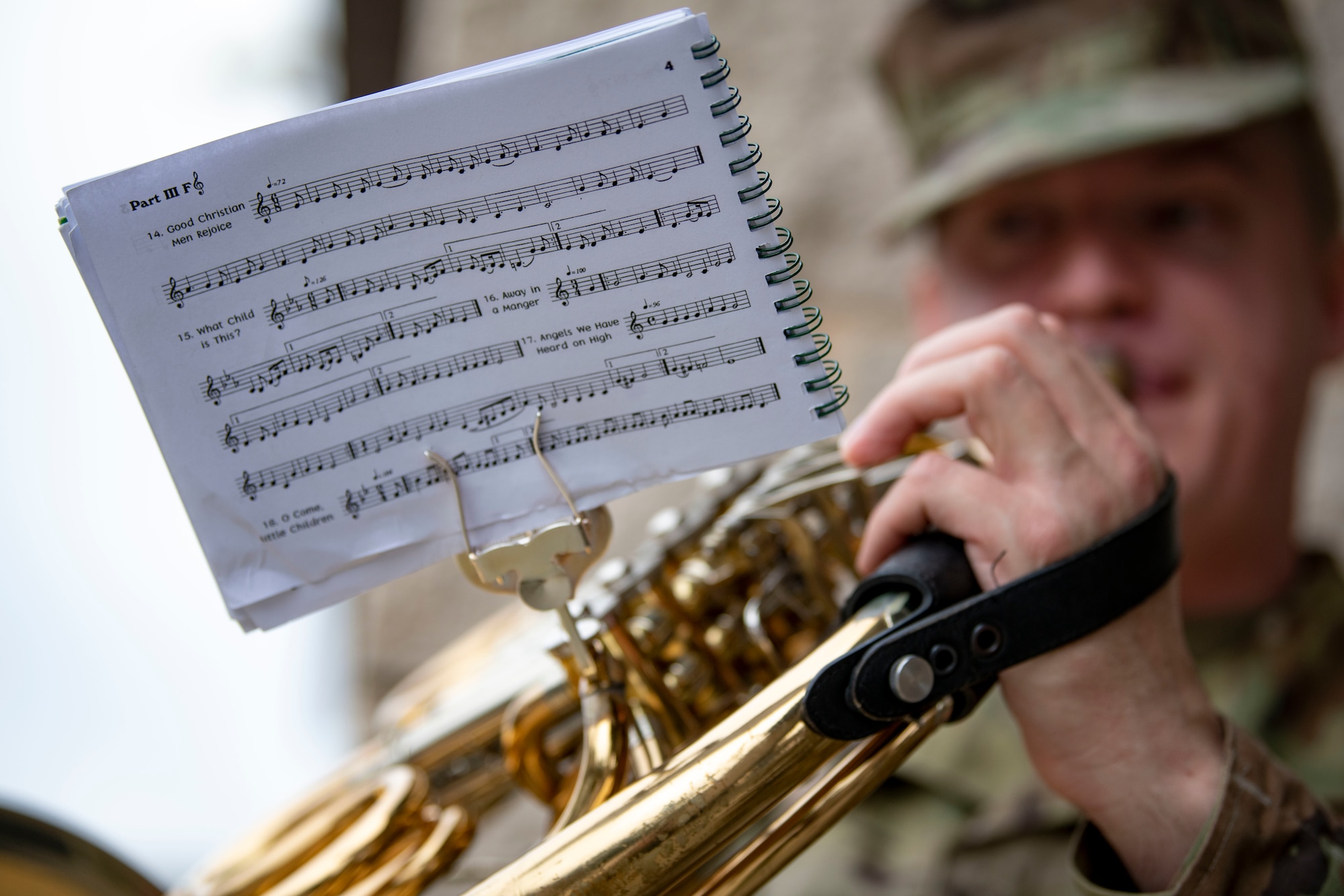 U.S. Air Force Staff Sgt. Justin Weisenborn, U.S. Air Force Band of the West trumpeter, plays holiday music during a caroling tour