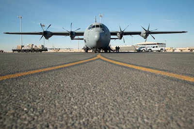 Members of the Iraqi and U.S. air force prepare to load cargo into an Iraqi C-130J Hercules at Ali Al Salem Air Base, Kuwait, Dec. 13, 2021. Since February 2021, the Iraqi Air Force has delivered 60 tons worth over $18 million enabling regional stability for the people of Iraq. (U.S. Army photo by Spc. Adaris Cole)