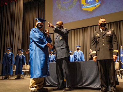 Nevada National Guard Maj. Gen. Ondra Berry, adjutant general, directs a Battle Born Youth ChalleNGe Academy student Dec. 17, 2021, during the graduation ceremony for the inaugural class in Elko, Nev. Twenty-one students graduated from the residential phase of the program.