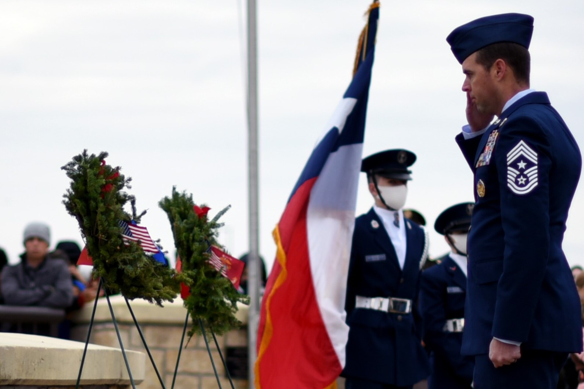 301st Fighter Wing Command Chief Master Sgt. Michael Senigo salutes the Air Force wreath during a Wreaths Across America event at the Dallas-Fort Worth National Cemetery on Dec. 18, 2021. Senigo and representatives from each branch laid their respective wreaths to honor their service men and women. (U.S. Air Force photo by Staff Sgt. Randall Moose)