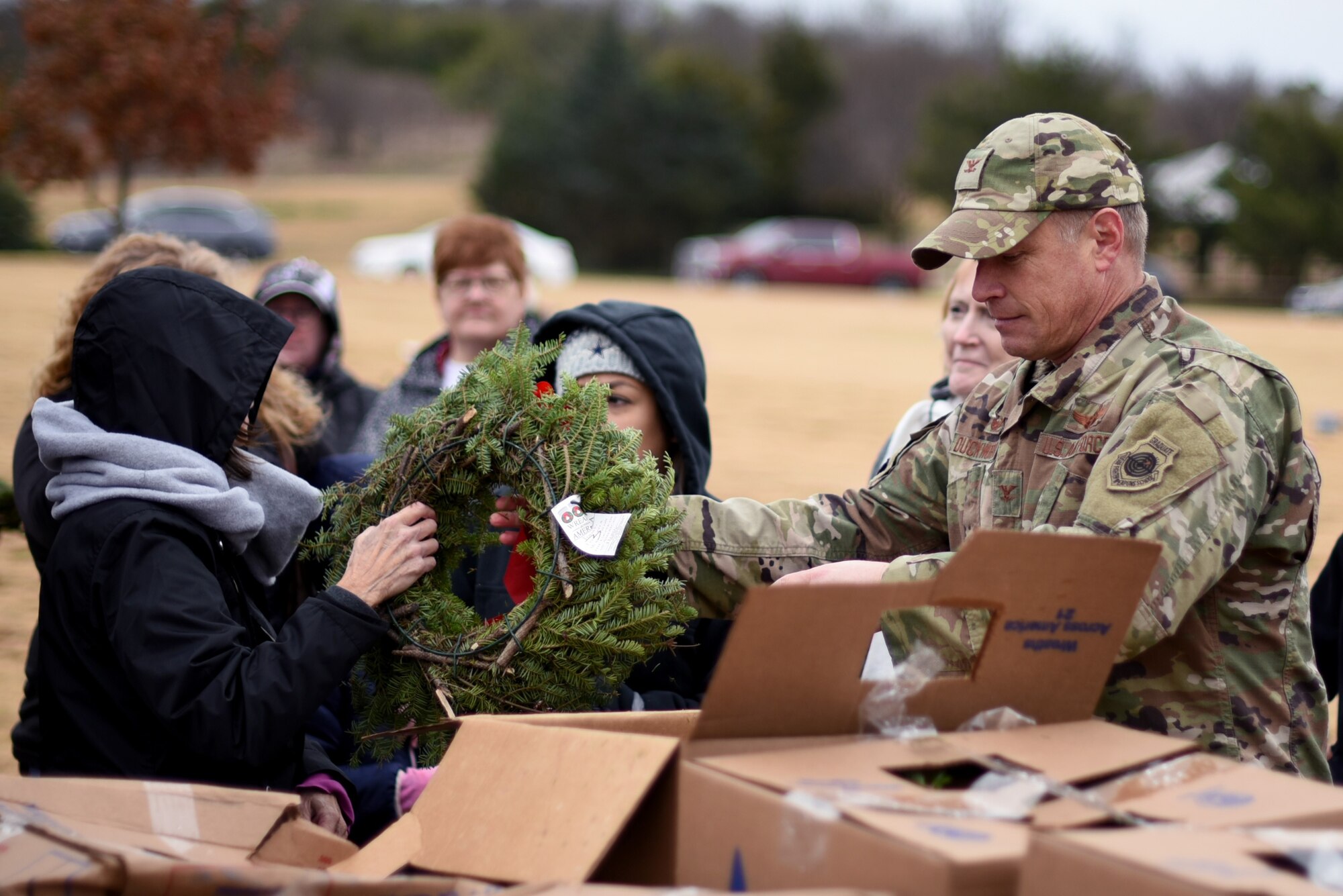 Col. Allen “Jaks” Duckworth, 301st Fighter Wing commander, distributes wreaths during a Wreaths Across America event at the Dallas-Fort Worth National Cemetery on Dec. 18, 2021. Airmen from the 301 FW participated to remember and honor their fellow service men and women. (U.S. Air Force photo by Staff Sgt. Randall Moose)