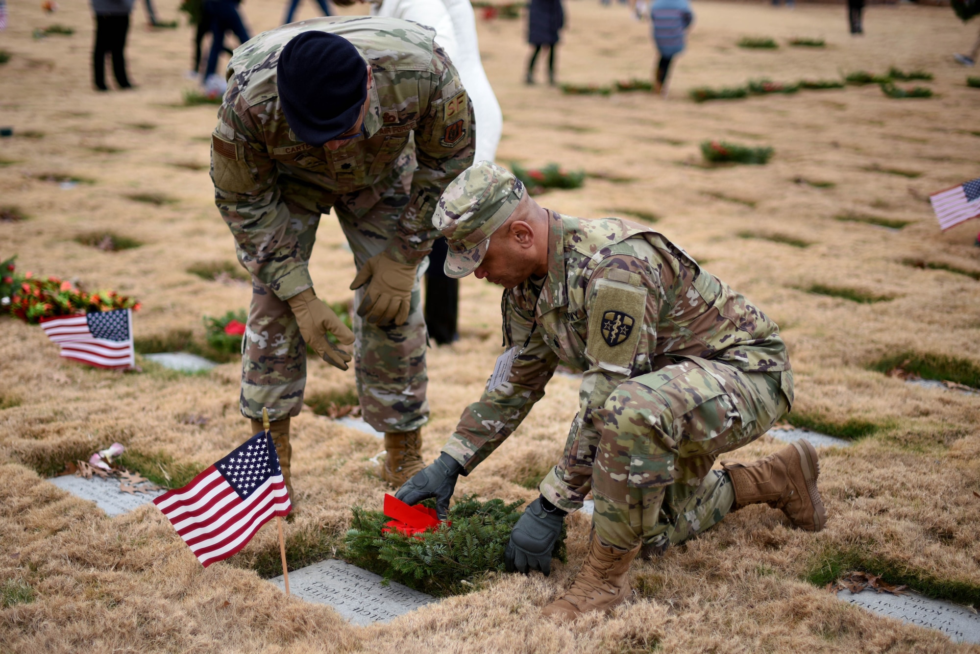 Lt. Col. Anthony Carter, 301st Fighter Wing Security Forces Squadron commander, and Lt. Col Angelo Carter, U.S. Army Reserve Medical Corps physician associate, lay a wreath for their father, Master Sgt. Algie Carter during a Wreaths Across America event at the Dallas-Fort Worth National Cemetery on Dec. 18, 2021. This even is a chance for many families to honor their loved ones that served as veterans. (U.S. Air Force photo by Staff Sgt. Randall Moose)