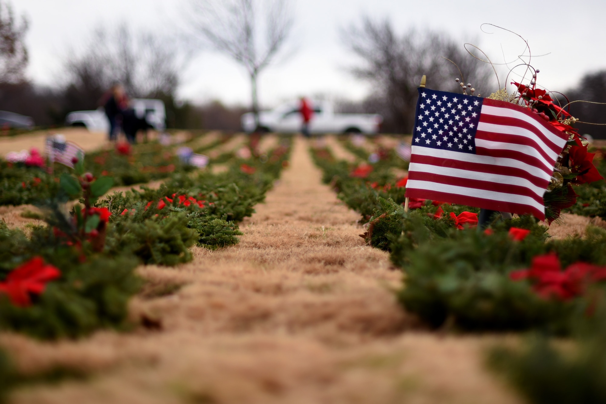 Wreaths lay near graves during a Wreaths Across America event at the Dallas-Fort Worth National Cemetery on Dec. 18, 2021. The Dallas-Fort Worth National Cemetery is the final resting place for 48,500 veterans. (U.S. Air Force photo by Staff Sgt. Randall Moose)