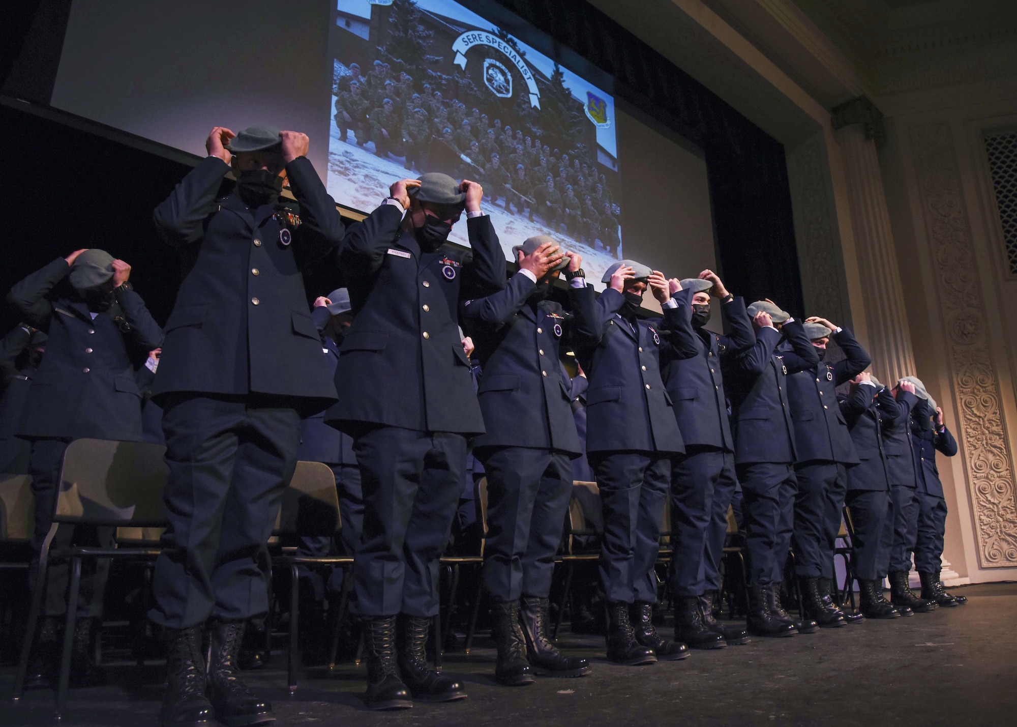 U.S. Air Force Survival Evasion Resistance Escape School graduates dawn their berets as part of the ceremony to become an official SERE specialist, in Spokane, Washington Dec. 17, 2021. The 336th Training Group held a graduation ceremony for its largest SERE Specialist Apprentice Course with an all-time high of 44 graduates. (U.S. Air Force photo by Airman 1st Class Anneliese Kaiser)