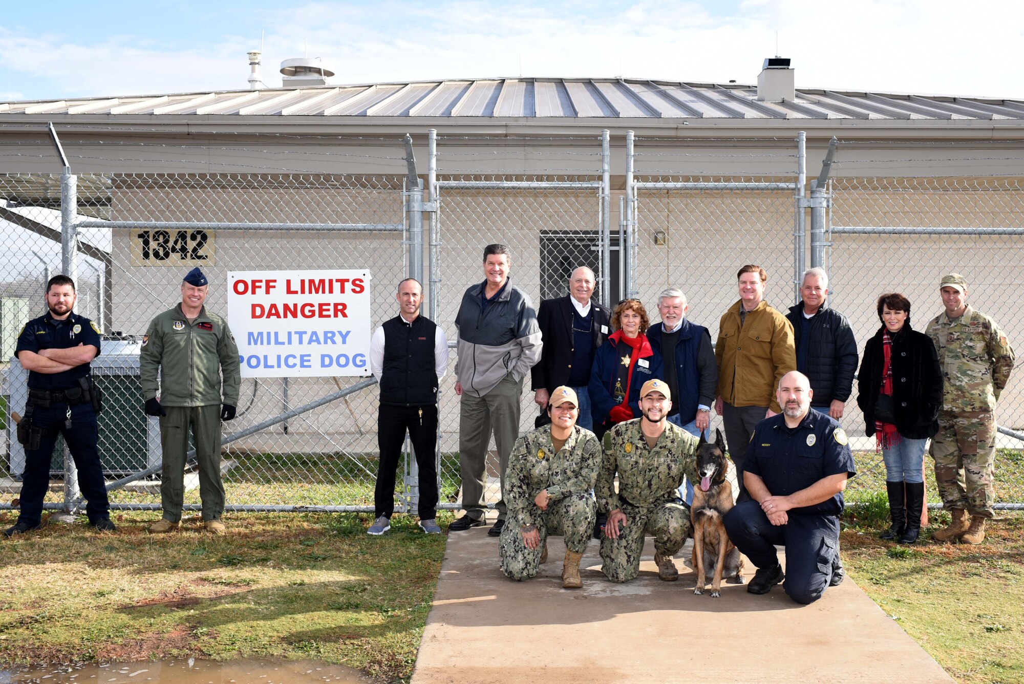 301st Fighter Wing Honorary Commanders and 301 FW leadership visit the military working dogs office during a tour at Naval Air Station Joint Reserve Base Fort Worth, Dec. 20, 2021. MWDs are service dogs capable of detecting explosives, narcotics and locating missing individuals. (U.S. Air Force photo by Staff Sgt. Randall Moose)