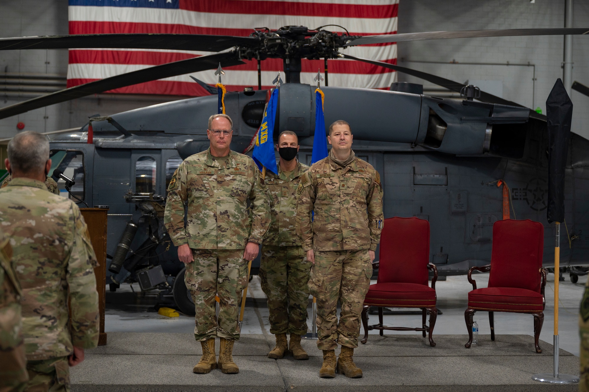 Two Airmen stand at attention.