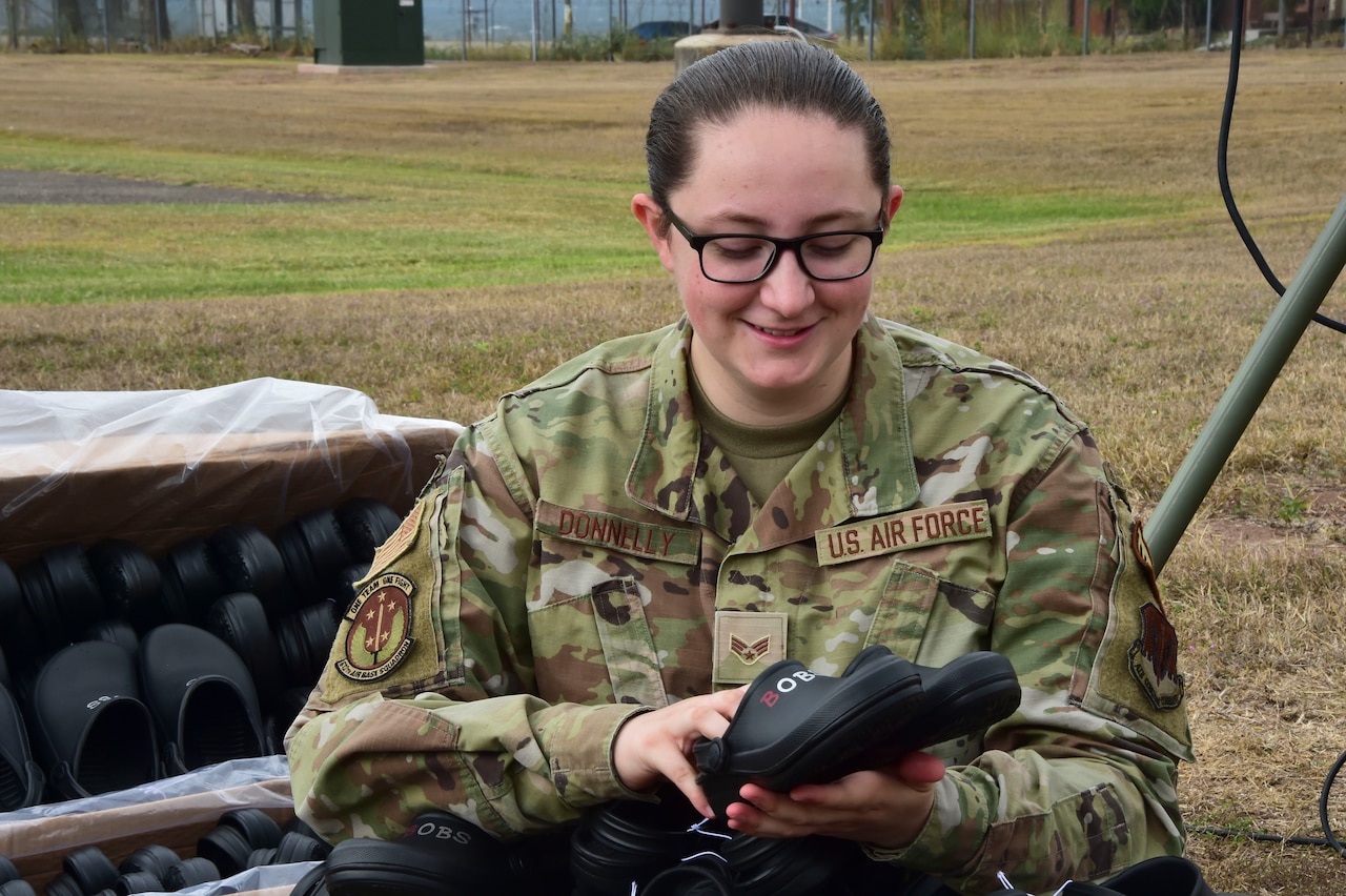 An airman organizes shoes.