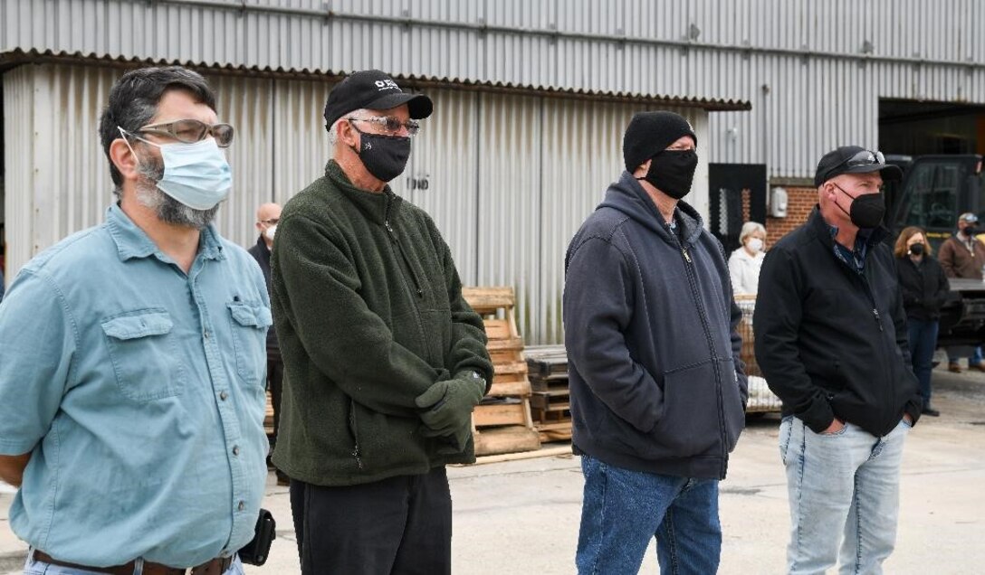 Dale Winland, second from left, and others listen during a memorial held in remembrance of John Hill and Alvin Overman who died 50 years ago working at Arnold Air Force Base, Tenn., Dec. 9, 2021. Winland is a nephew of Overman and a current employee at Arnold AFB. (U.S. Air Force photo by Jill Pickett)