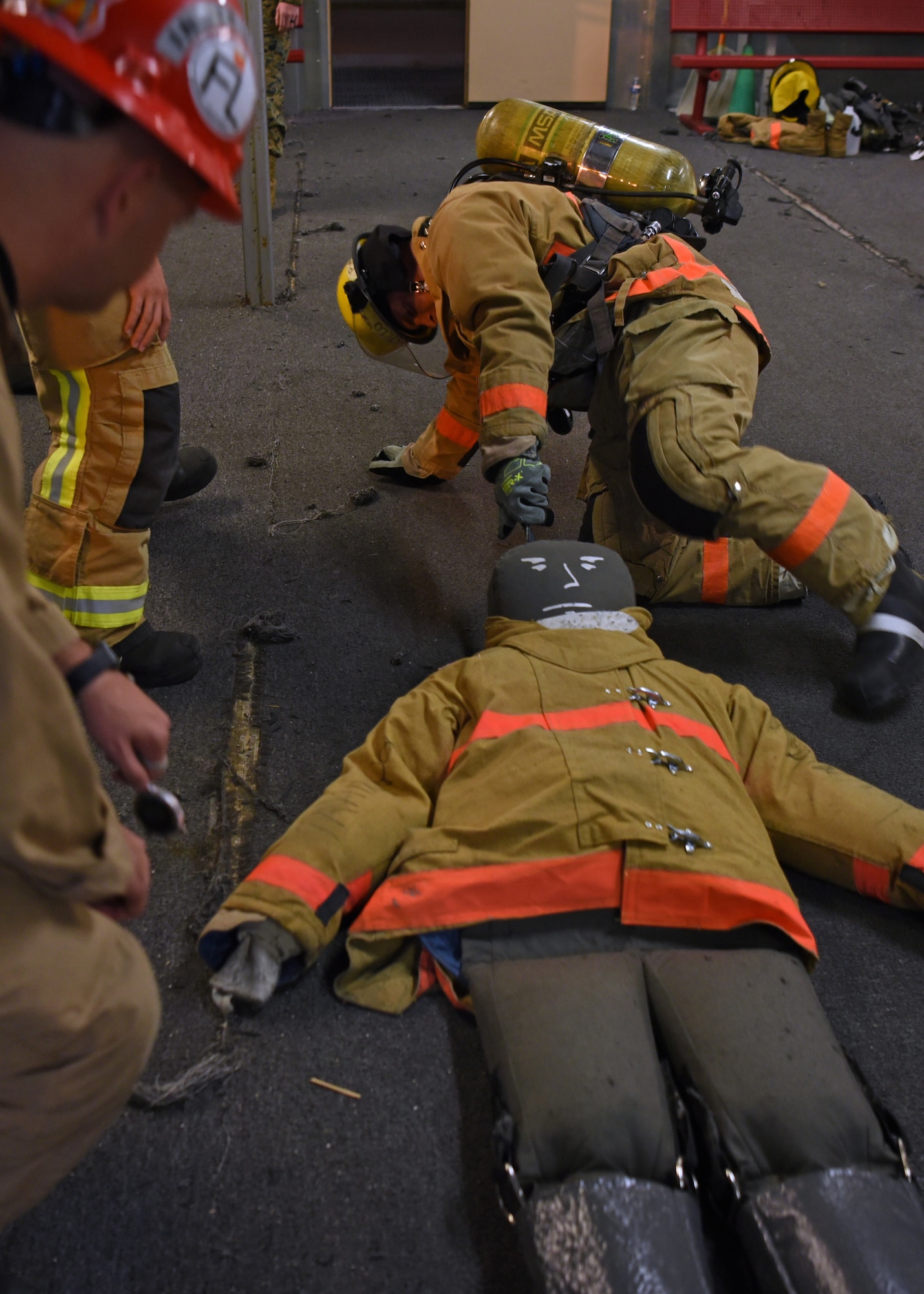 U.S. Army Staff Sgt. Jonathan Perry, 169th Engineer Battalion fire protection instructor, encourages a student during victim removal training on Goodfellow Air Force Base, Texas, Nov. 2, 2021. Student undergoes 68 training days at the Louis F. Garland Department of Defense Fire Academy. (U.S. Air Force photo by Senior Airman Abbey Rieves)