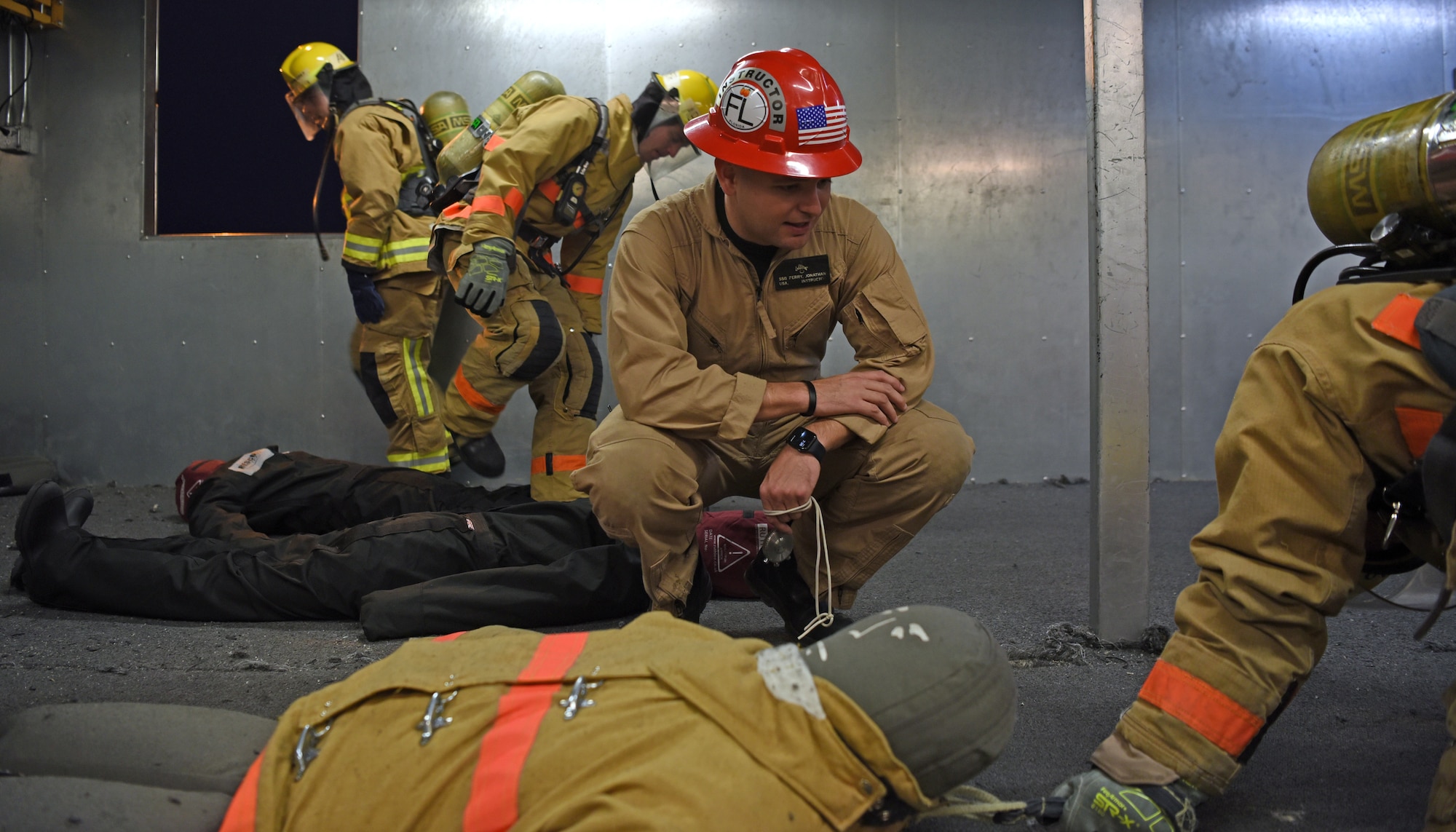 U.S. Army Staff Sgt. Jonathan Perry, 169th Engineer Battalion fire protection instructor, times a student during victim removal training on Goodfellow Air Force Base, Texas, Nov. 2, 2021. Perry, another instructor and additional community members, provided rescue efforts for a motor vehicle accident on June 7. (U.S. Air Force photo by Senior Airman Abbey Rieves)
