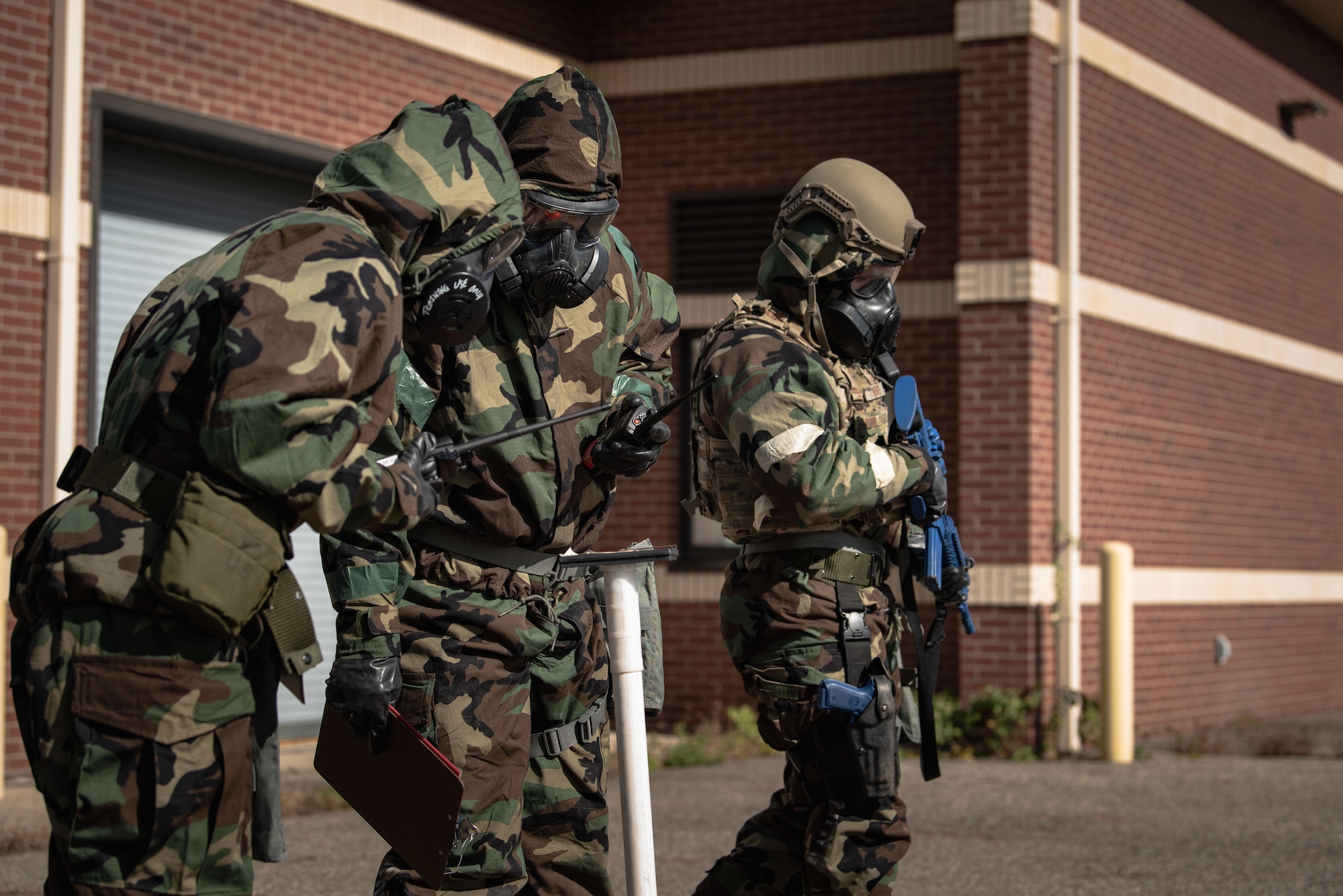 Members of the 110th Wing Medical Group, Force Support Squadron and Security Forces Squadron conduct a post-attack reconnaissance (PAR) sweep after a simulated rocket attack during an exercise at the Battle Creek Air National Guard Base, Michigan, Oct. 23, 2021. PAR teams conduct these sweeps to check for casualties, unexploded ordinances, and contamination from chemical, biological, radiological or nuclear weapons. (U.S. Air National Guard photo by Senior Airman Ryan Bishop)