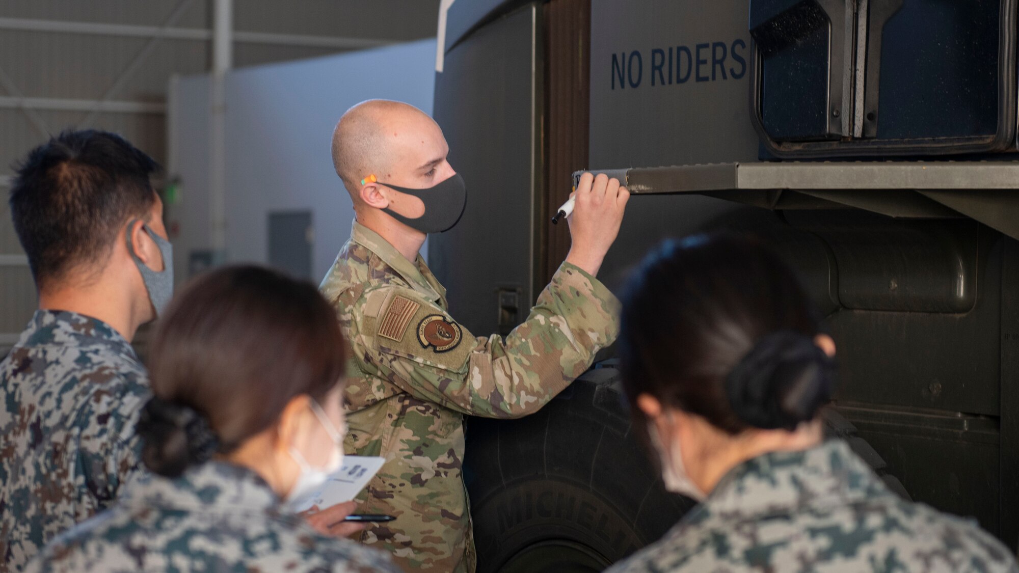 A U.S. Air Force Airman writes down the rear weight of a 10K All-Terrain Forklift on a piece of tape