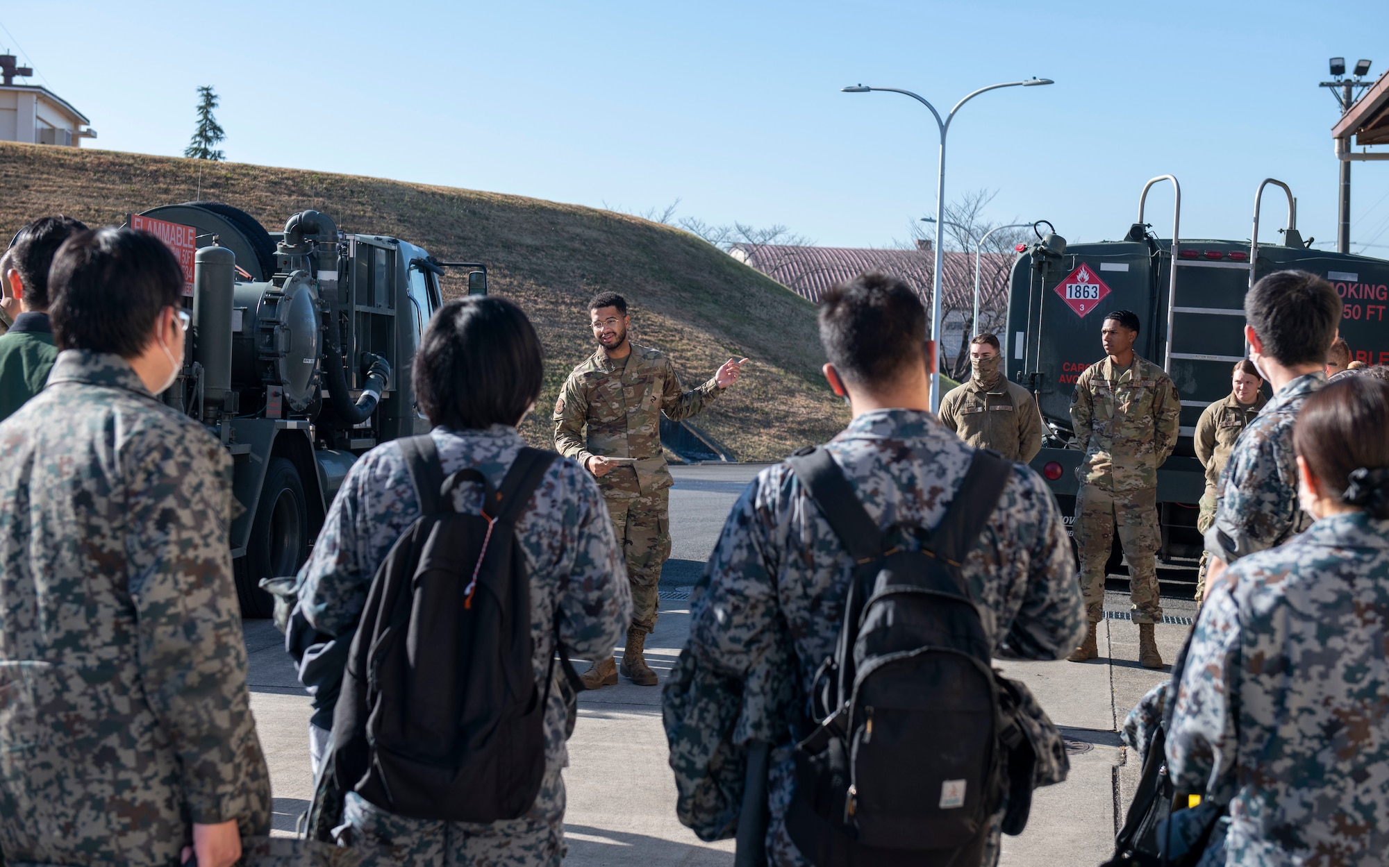 A U.S. Air Force Airman welcomes members of the Japan Air Self Defense Force