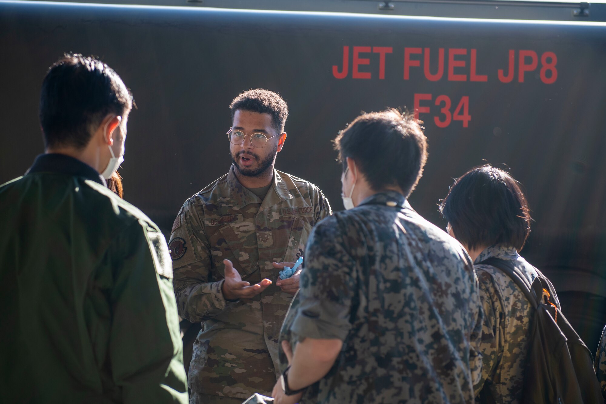 A U.S. Air Force Airman briefs members of the Japan Air Self Defense Force
