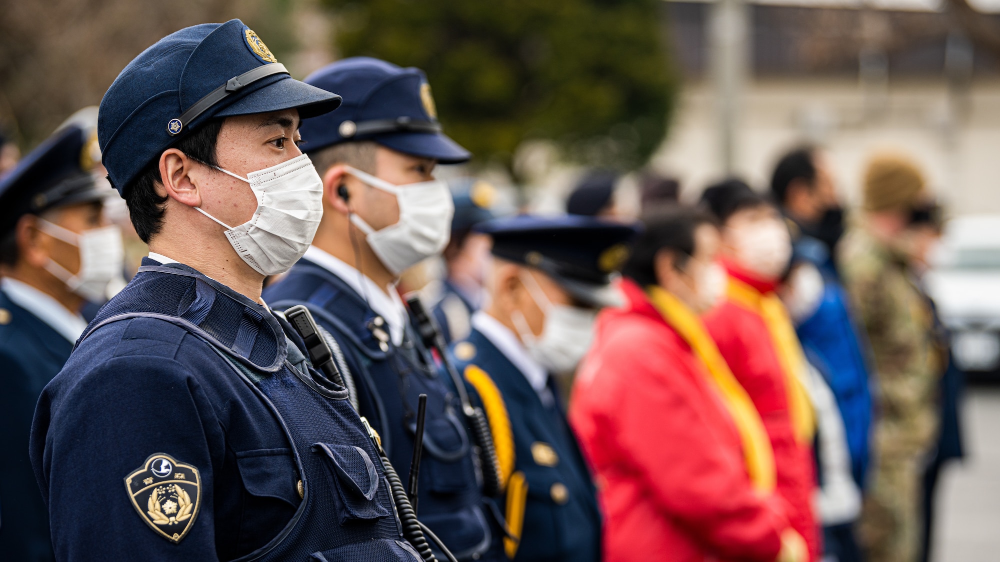 Service members, community members, and Misawa City police officers come together during the End-of-Year Traffic Safety and Crime Prevention Campaign in Misawa City, Japan, Dec. 16, 2021. During the campaign, 35th Fighter Wing, Misawa City and police leadership distributed flyers with information on what to do if anyone in the community finds themselves in an unsafe environment. (U.S. Air Force photo by Staff Sgt. Jao’Torey Johnson)