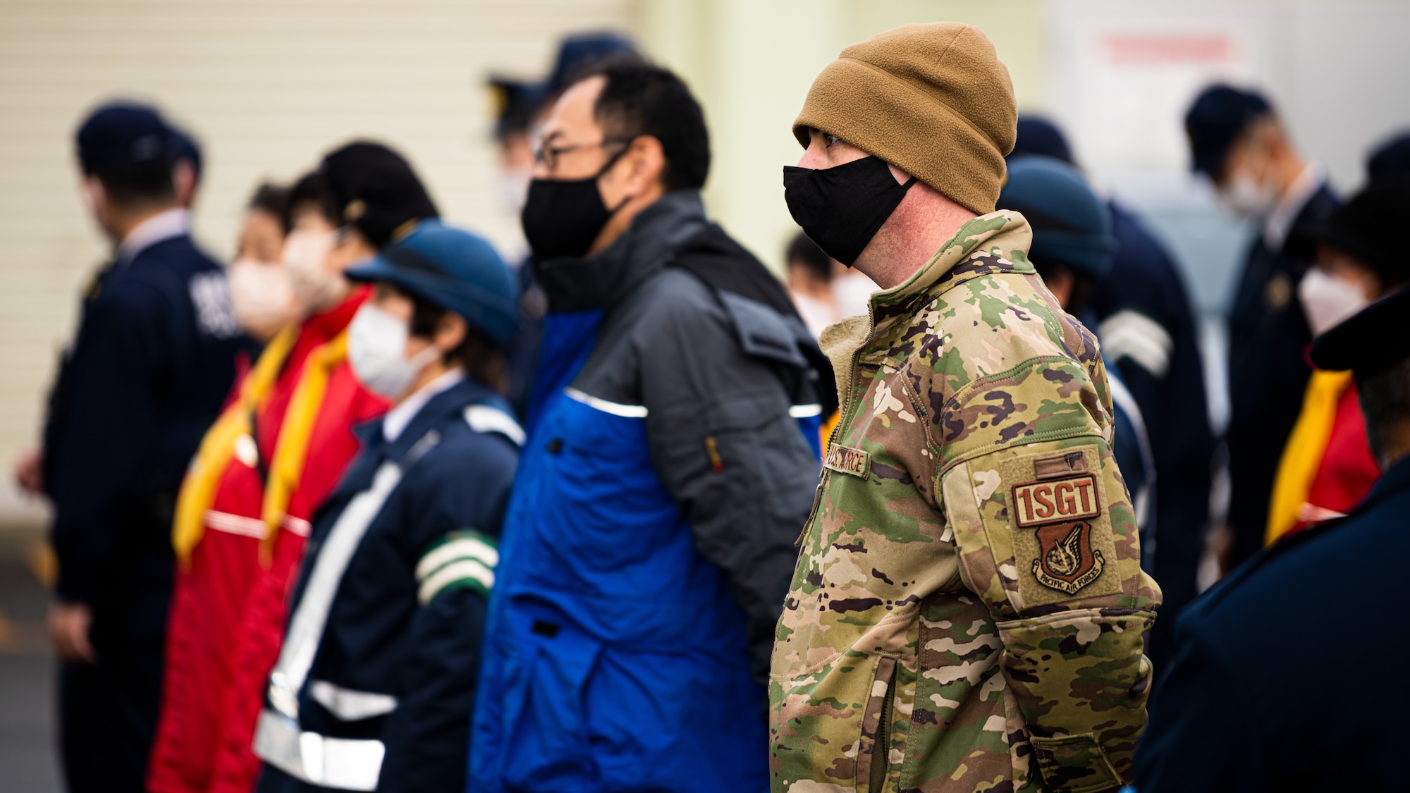 Service members, community members, and Misawa City police officers come together during the End-of-Year Traffic Safety and Crime Prevention Campaign in Misawa City, Japan, Dec. 16, 2021. During the campaign, 35th Fighter Wing, Misawa City and police leadership distributed flyers with information on what to do if anyone in the community finds themselves in an unsafe environment. (U.S. Air Force photo by Staff Sgt. Jao’Torey Johnson)