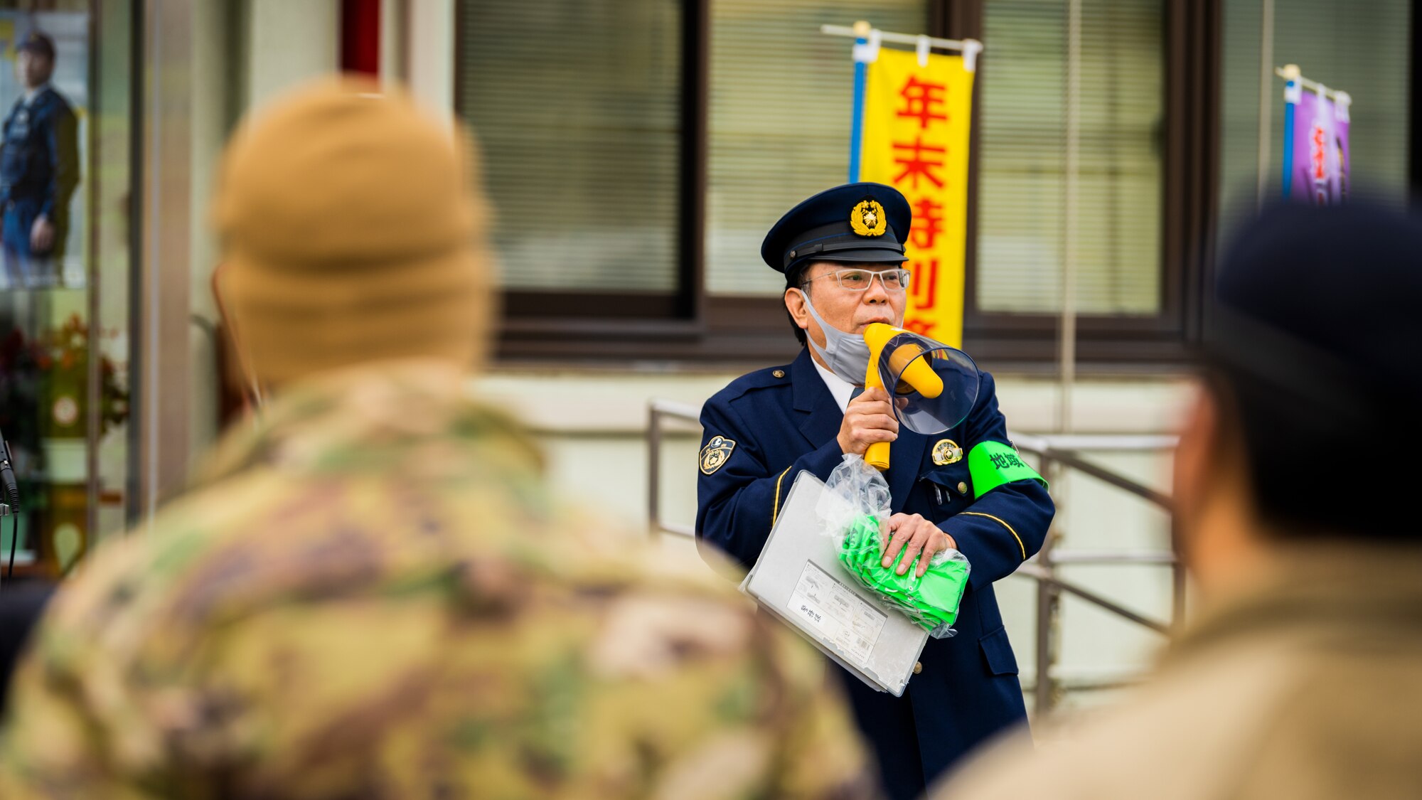 Service members, community members, and Misawa City police officers come together during the End-of-Year Traffic Safety and Crime Prevention Campaign in Misawa City, Japan, Dec. 16, 2021. During the campaign, 35th Fighter Wing, Misawa City and police leadership distributed flyers with information on what to do if anyone in the community finds themselves in an unsafe environment. (U.S. Air Force photo by Staff Sgt. Jao’Torey Johnson)