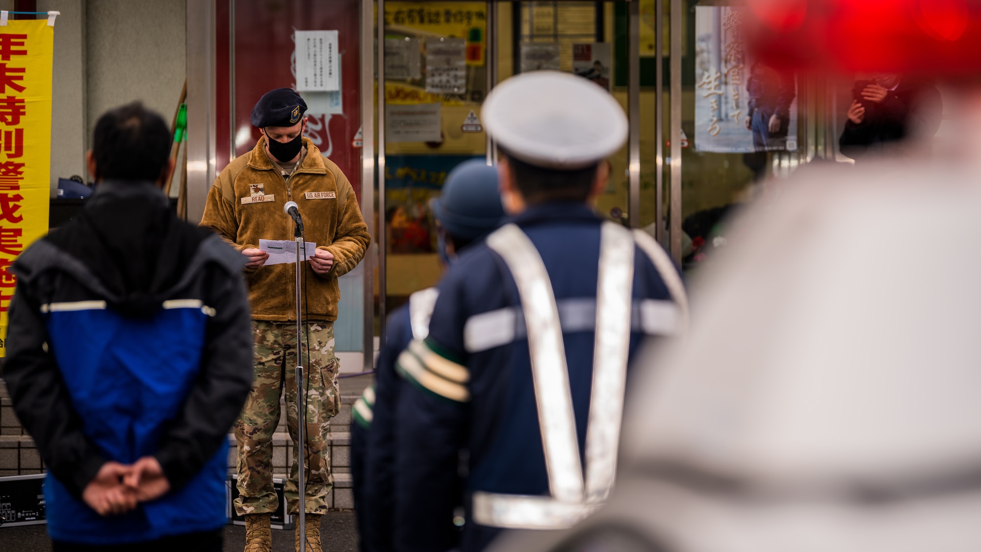 Service members, community members, and Misawa City police officers come together during the End-of-Year Traffic Safety and Crime Prevention Campaign in Misawa City, Japan, Dec. 16, 2021. During the campaign, 35th Fighter Wing, Misawa City and police leadership distributed flyers with information on what to do if anyone in the community finds themselves in an unsafe environment. (U.S. Air Force photo by Staff Sgt. Jao’Torey Johnson)