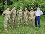 Tech. Sgt. Paul Cange, far left, and Cpl. Dakoatah Miller, far right, join the other American graduates of the Brazilian Jungle Operations International Course in Manaus, Brazil, Nov. 11, 2021. Brazil’s Jungle Warfare Center conducts a special shortened course for foreign students each fall.