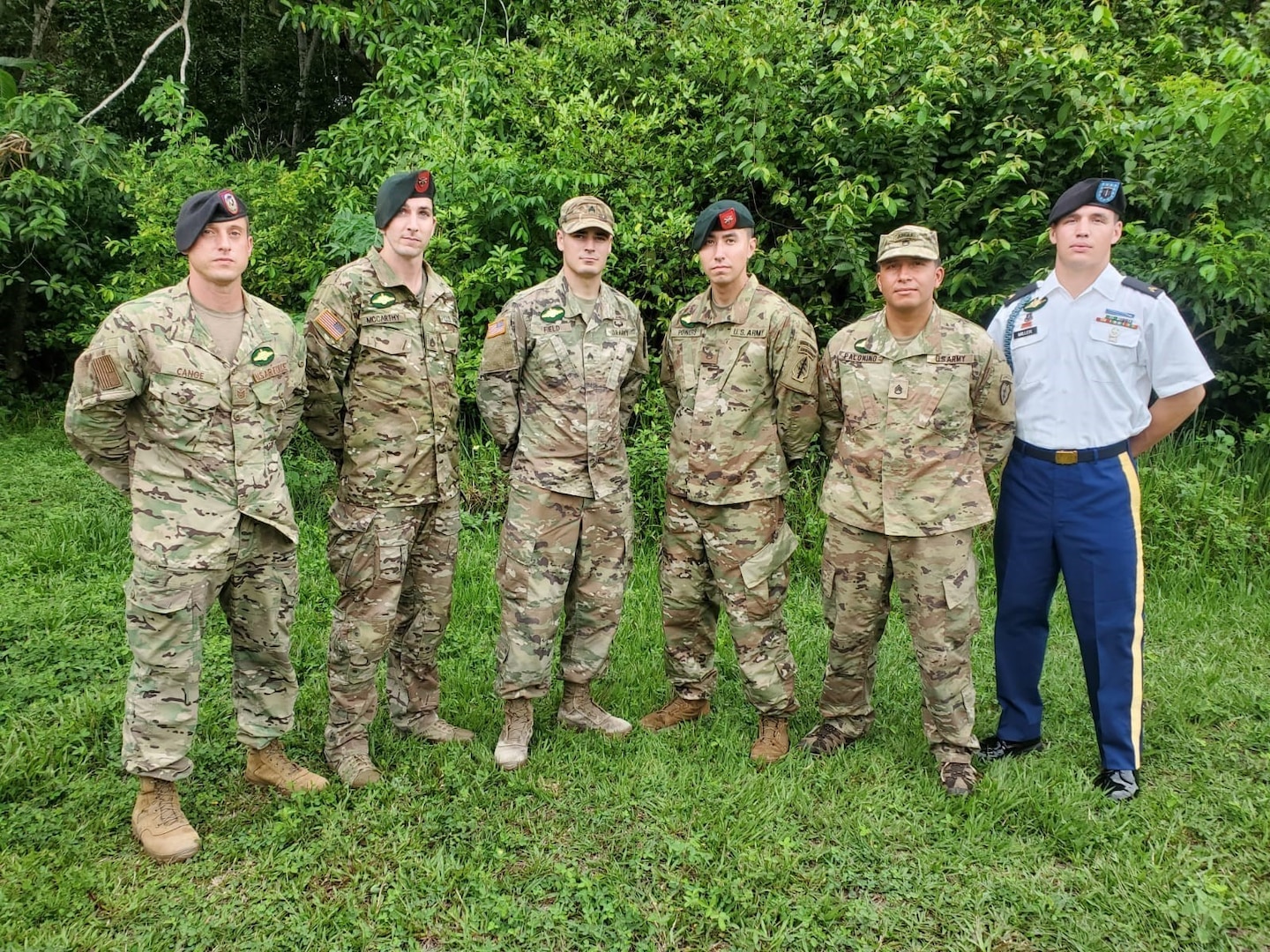 Tech. Sgt. Paul Cange, far left, and Cpl. Dakoatah Miller, far right, join the other American graduates of the Brazilian Jungle Operations International Course in Manaus, Brazil, Nov. 11, 2021. Brazil’s Jungle Warfare Center conducts a special shortened course for foreign students each fall.