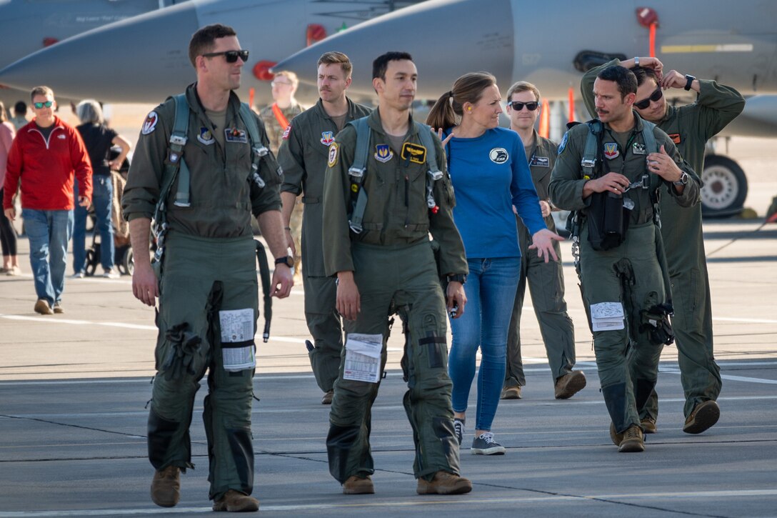 United States Air Force Weapons School instructors and students, including Maj. Michael Tope and Maj. Rodolfo Cruz (center) walk toward the hangar following a defensive combat air vul at Nellis Air Force Base, Nevada, Dec. 8, 2021. This flight marked the final flight for the F-15C Weapons Instructor Course.
