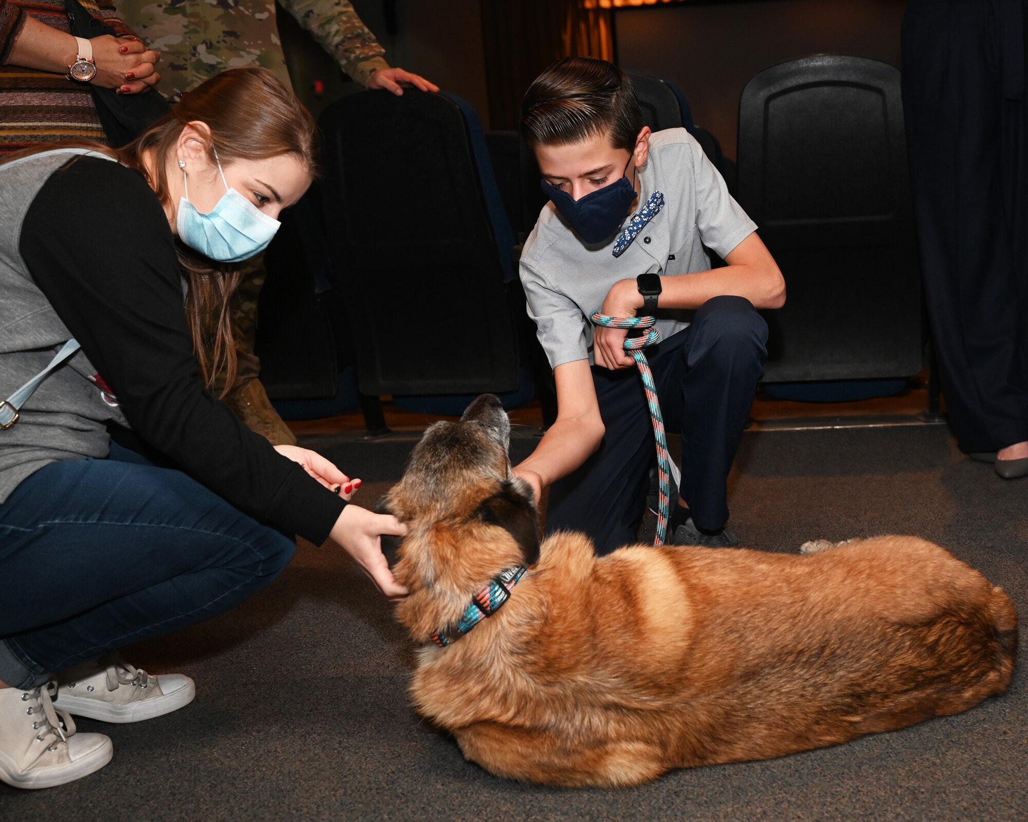 17th Security Forces Squadron Military Working Dog Joy is recognized during her retirement ceremony at the theater on Goodfellow Air Force Base, Dec. 20. Joy has been living with the Reilman family since the beginning of September, 2021. (U.S. Air Force photo by Senior Airman Michael Bowman)