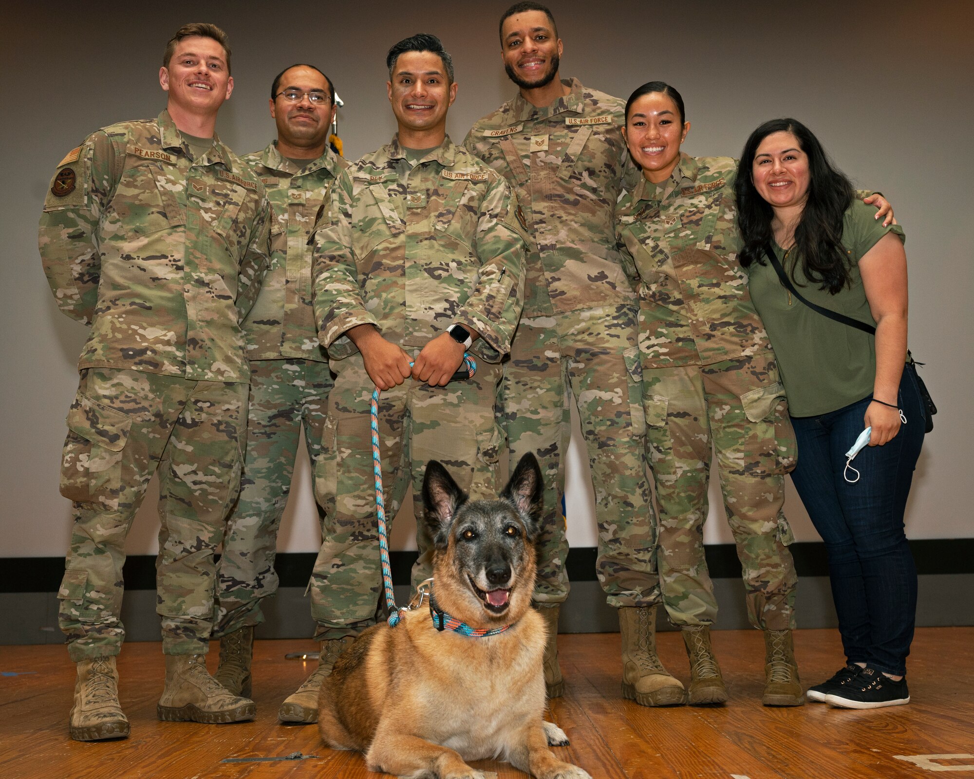 17th Security Forces Squadron Military Working Dog Joy is recognized during her retirement ceremony at the theater on Goodfellow Air Force Base, Dec. 20. Members of the 17th SFS got to say their final farewells to their longtime wingman as she transitioned into retirement. (U.S. Air Force photo by Senior Airman Michael Bowman)