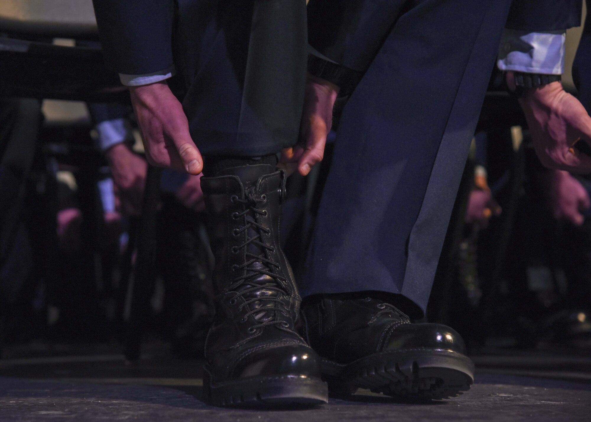 U.S. Air Force Survival Evasion Resistance Escape School graduates ceremonial blouse their boots as part of their ceremony, in Spokane, Washington Dec. 17, 2021. The 336th Training Group held a graduation ceremony for its largest SERE Specialist Apprentice Course with an all-time high of 44 graduates. (U.S. Air Force photo by Airman 1st Class Anneliese Kaiser)