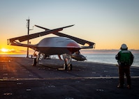 A Boeing unmanned MQ-25 aircraft is towed on the flight deck aboard the aircraft carrier USS George H.W. Bush (CVN 77).