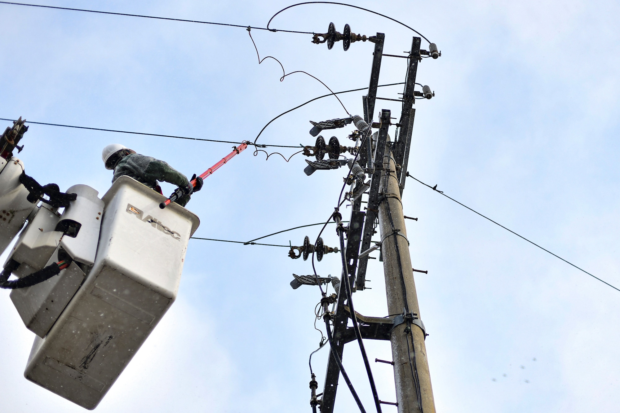 An electrician repairs a power line.